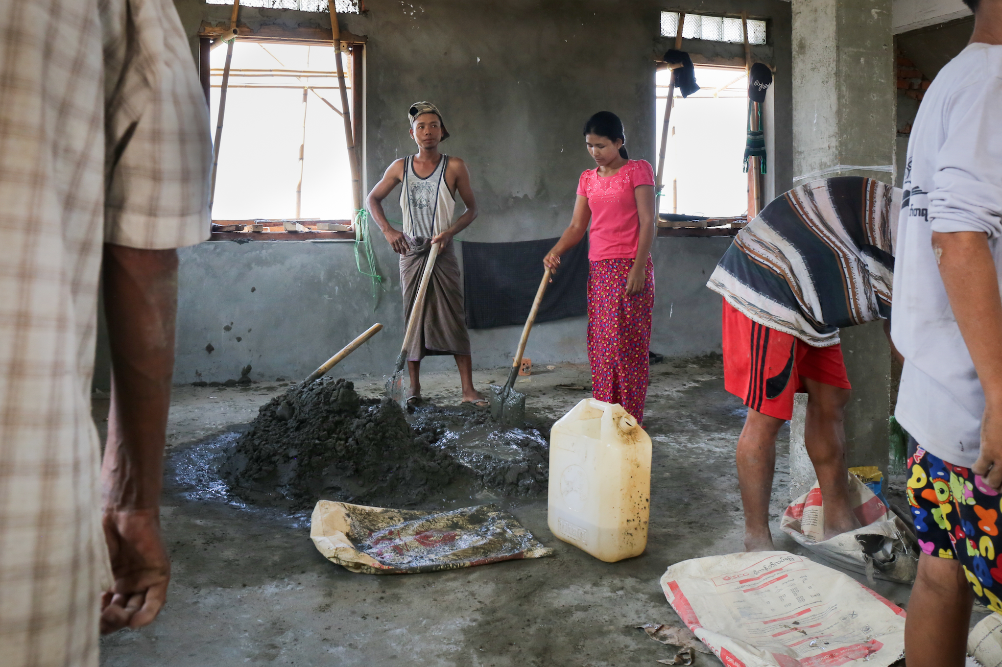 Workers build a new cyclone shelter. My coworker and I drove through the delta for hours and only came across a few shelters- certainly not enough to provide reasonable shelter in the case of another major storm. Irrawaddy Delta, Myanmar