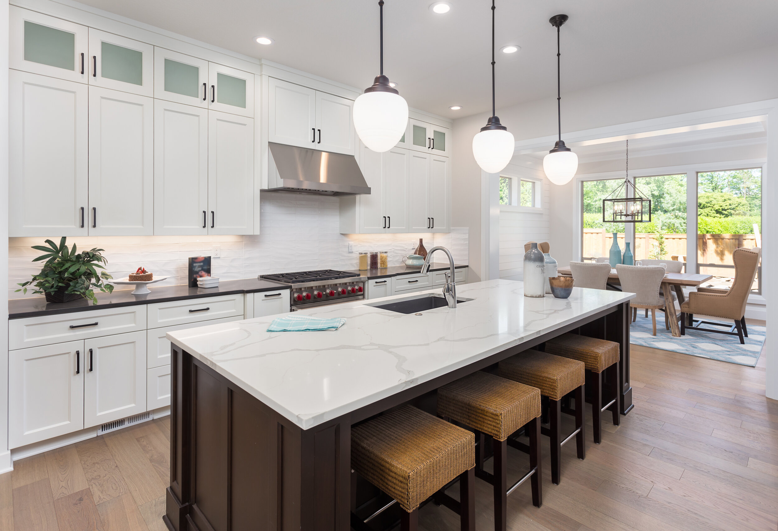 beautiful-kitchen-in-new-luxury-home-with-island,-pendant-lights,-and-hardwood-floors.-Includes-view-of-dining-room.-692601402_4000x2728.jpeg