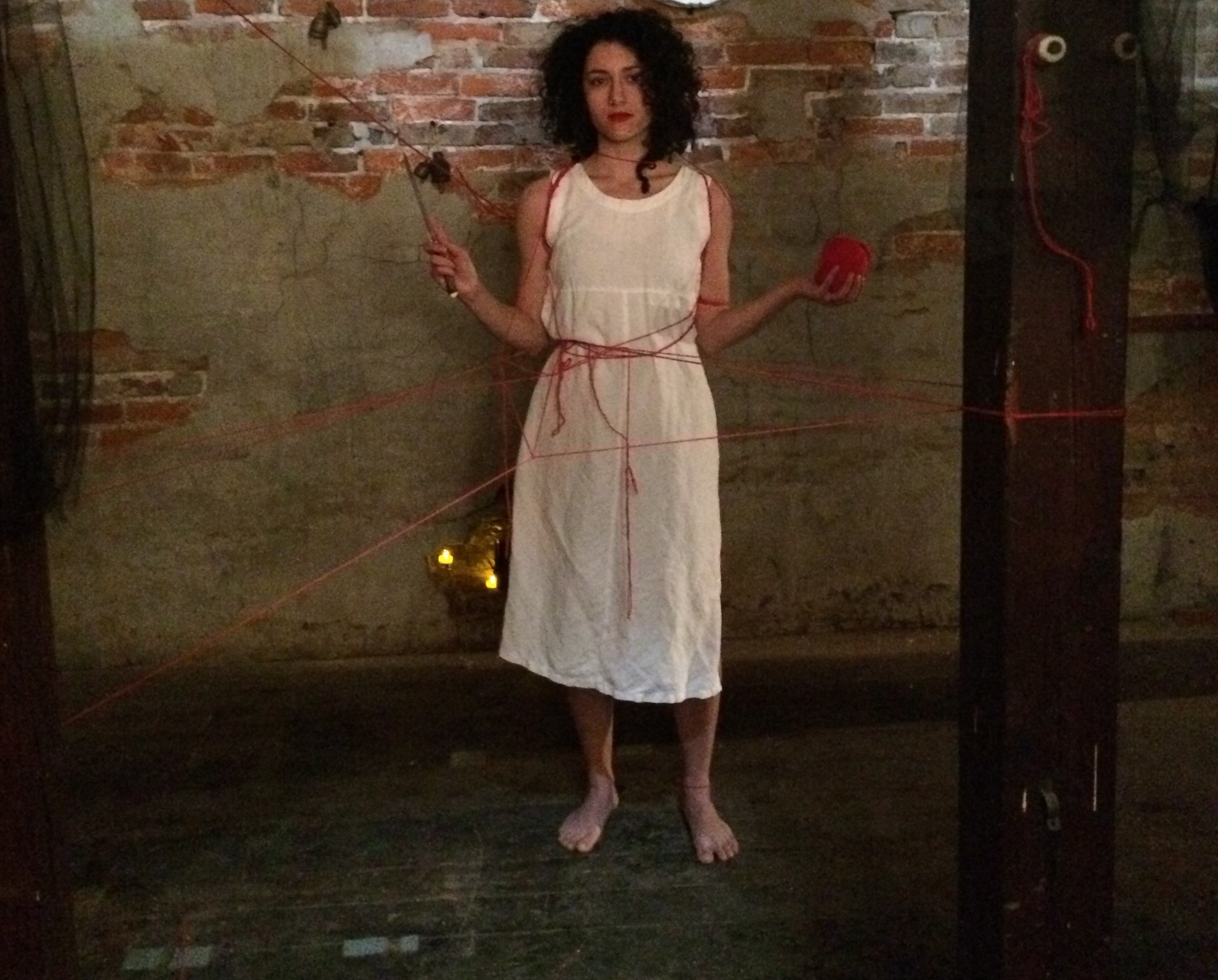 Elizabeth Weinstein offers audience members a choice at Almanac Circus Dance Theatre's event, THE FLEECING. Photo: Morgan F.P. Andrews.