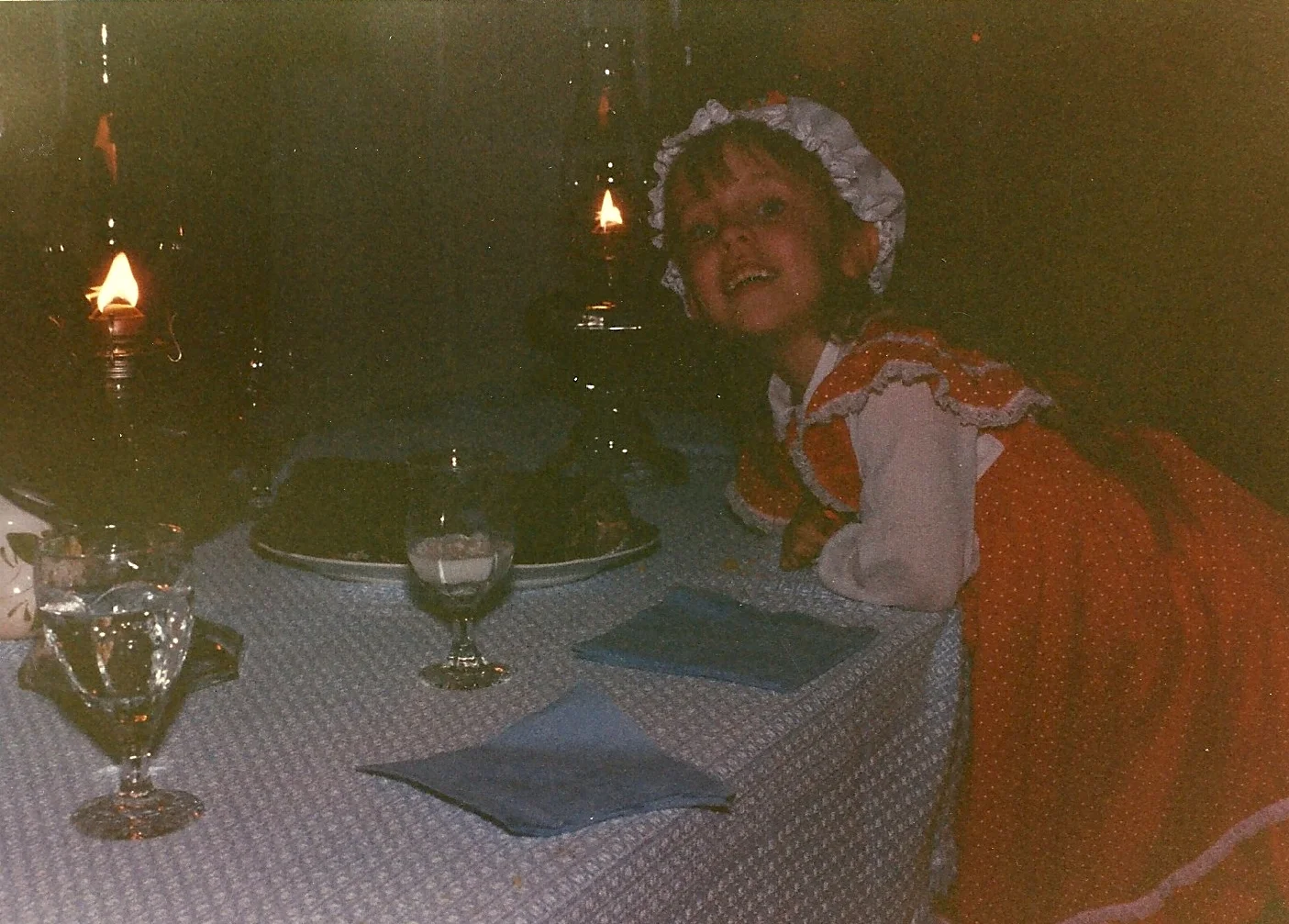 A young me, proudly posing before our dimly-lit colonial dinner table. Apparently, they pulled out all the stops in George Washington's day with blue paper napkins. 
