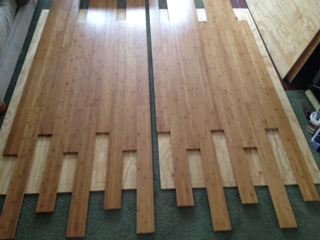 This was the start of getting the bamboo flooring laid out. It's not the most conventional approach but I decided to glue and nail the bamboo onto sheets of plywood to make two removeable floor panels for the living room area in the front of