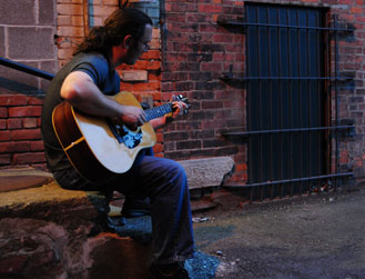 greg-on-steps-with-bricks-web.jpg