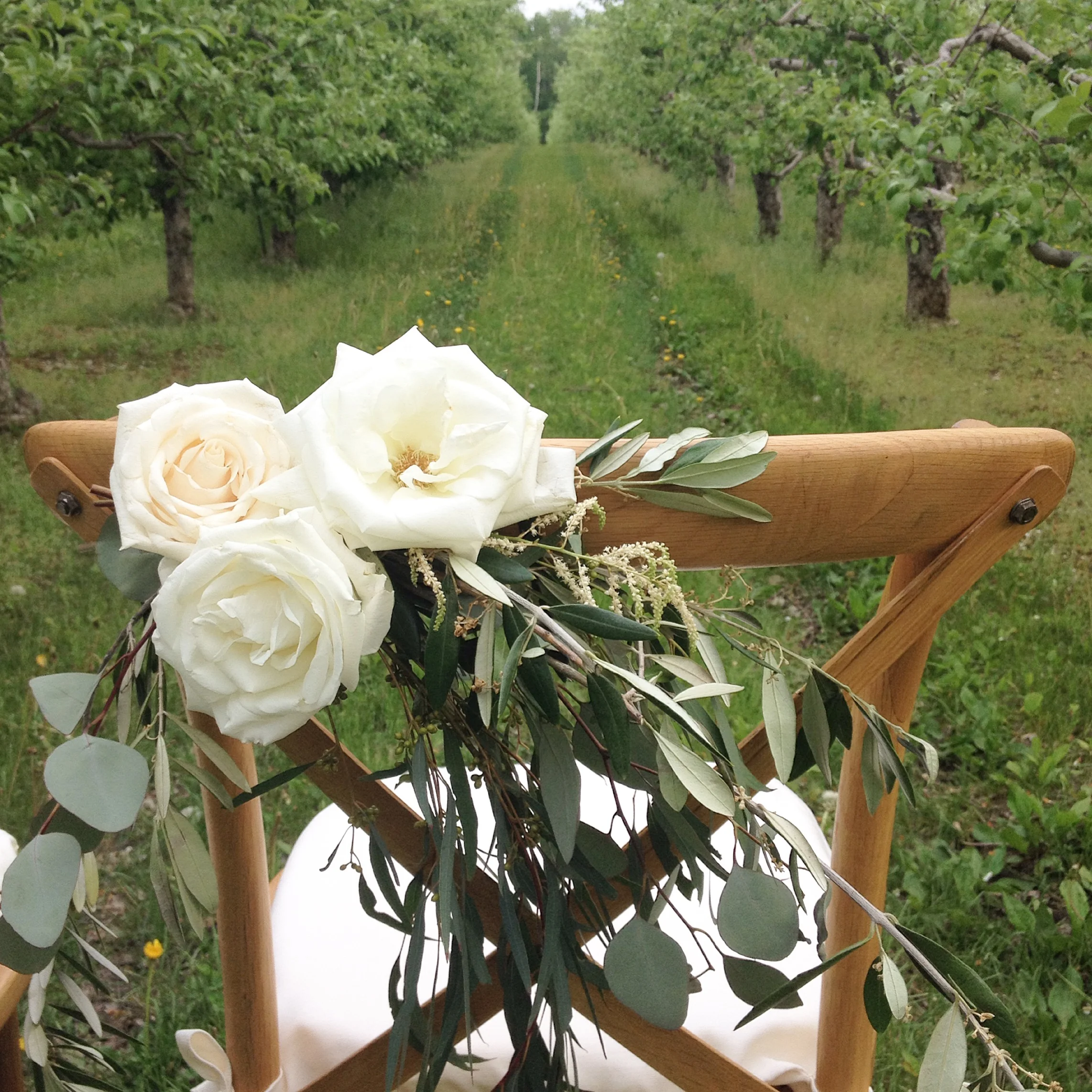 Flower detail on the bride and grooms chairs...So pretty!