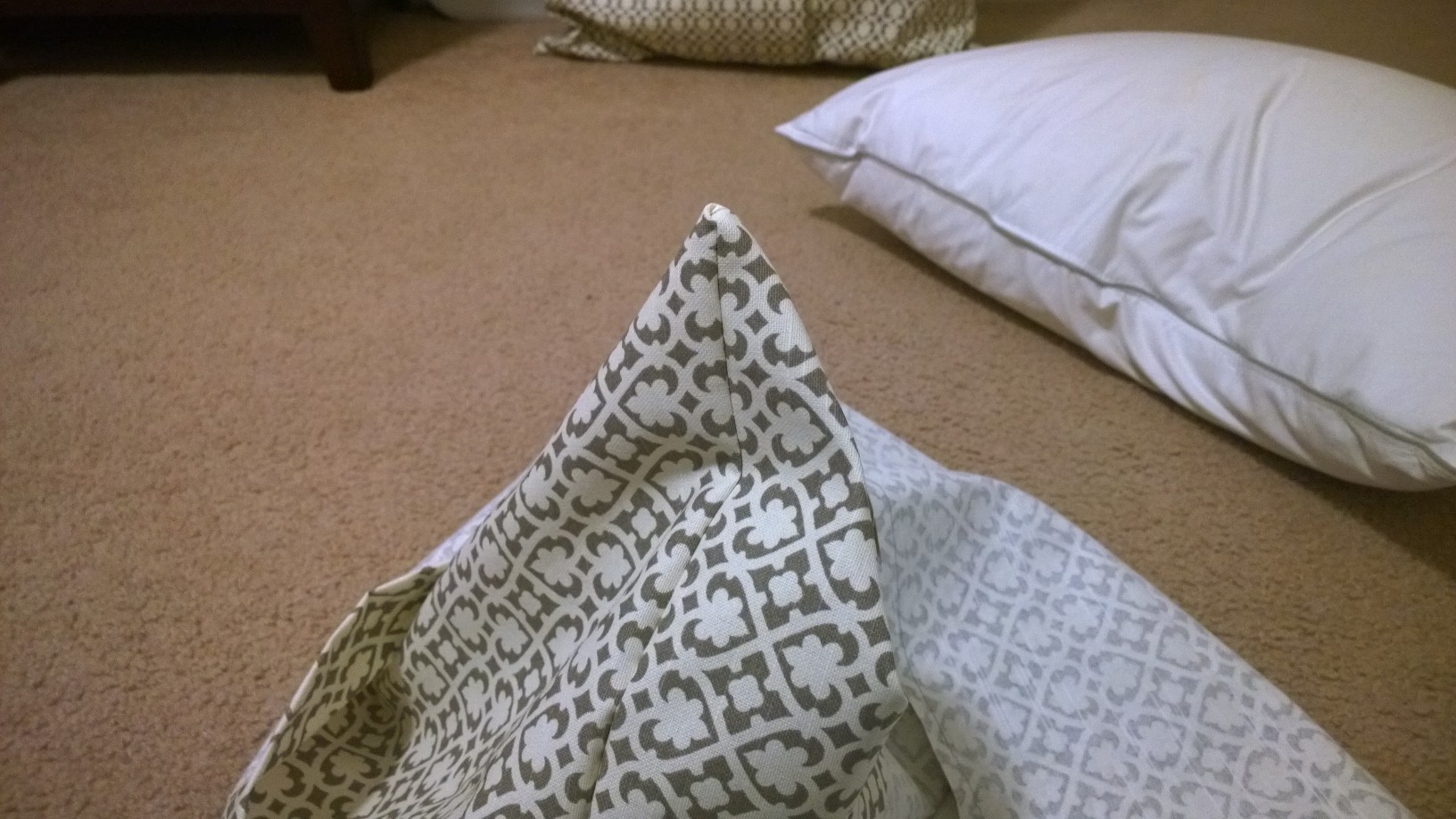 Once all three pieces were sewn, turning the pillow inside out, pressing the corners out to show finished edges