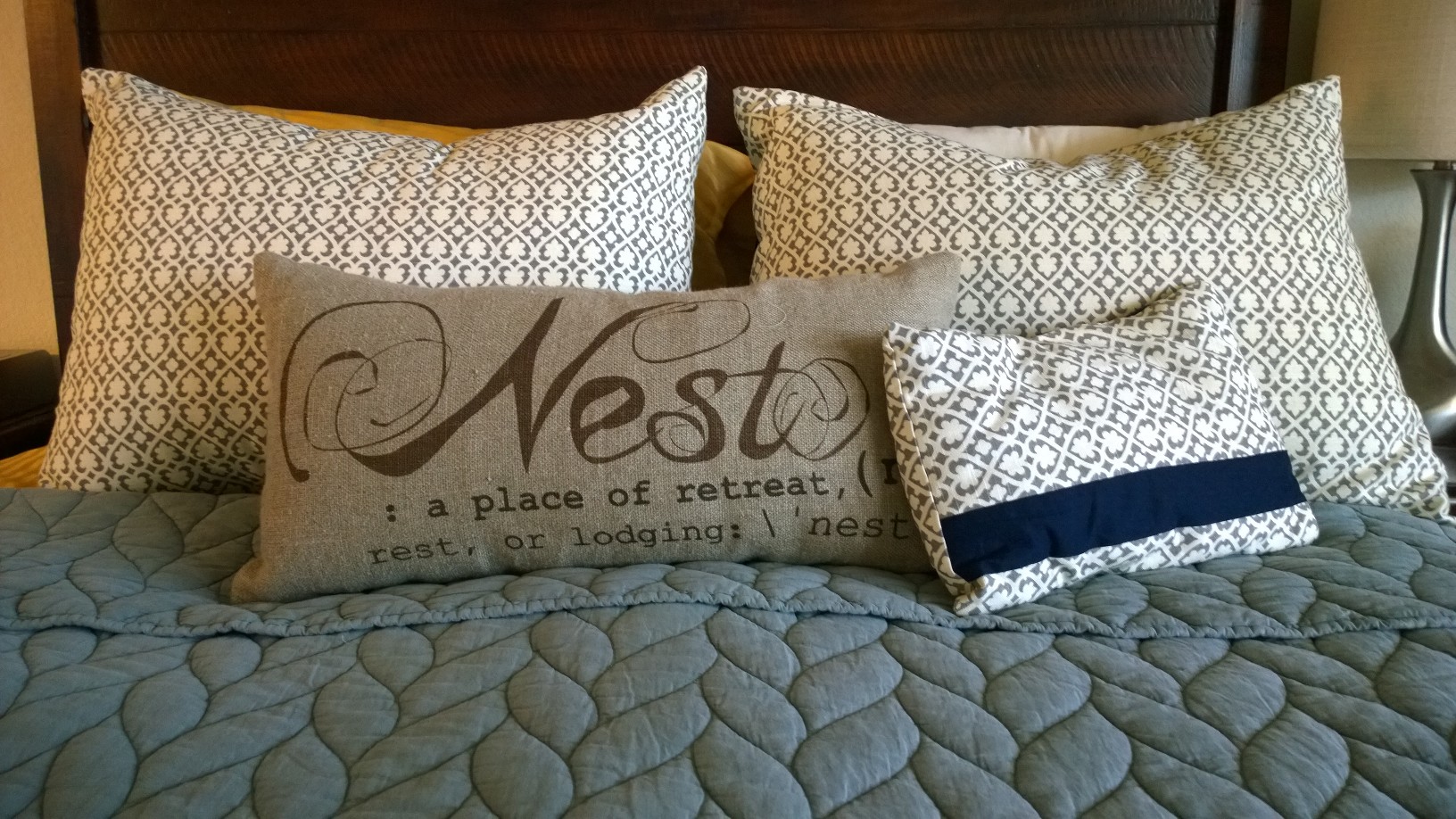 Final product on the master bed. The "nest" pillow is from Pottery Barn and the Quilt on our bed is from West Elm.