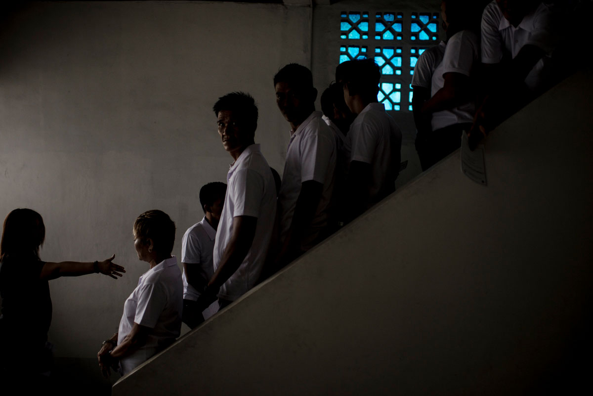 Drug rehab patients line up as they prepare for their graduation after a three-month program in a community rehab center in Caloocan City, Philippines. Their completion of the community drug rehab program lifts their names from the Philippine government's drug watch list--a list composed of suspected drug users and pushers in every village, gathered by village chairmen. In Caloocan, many from the drug watch list have been killed in police operations, or shot by unidentified assailants. © Eloisa Lopez