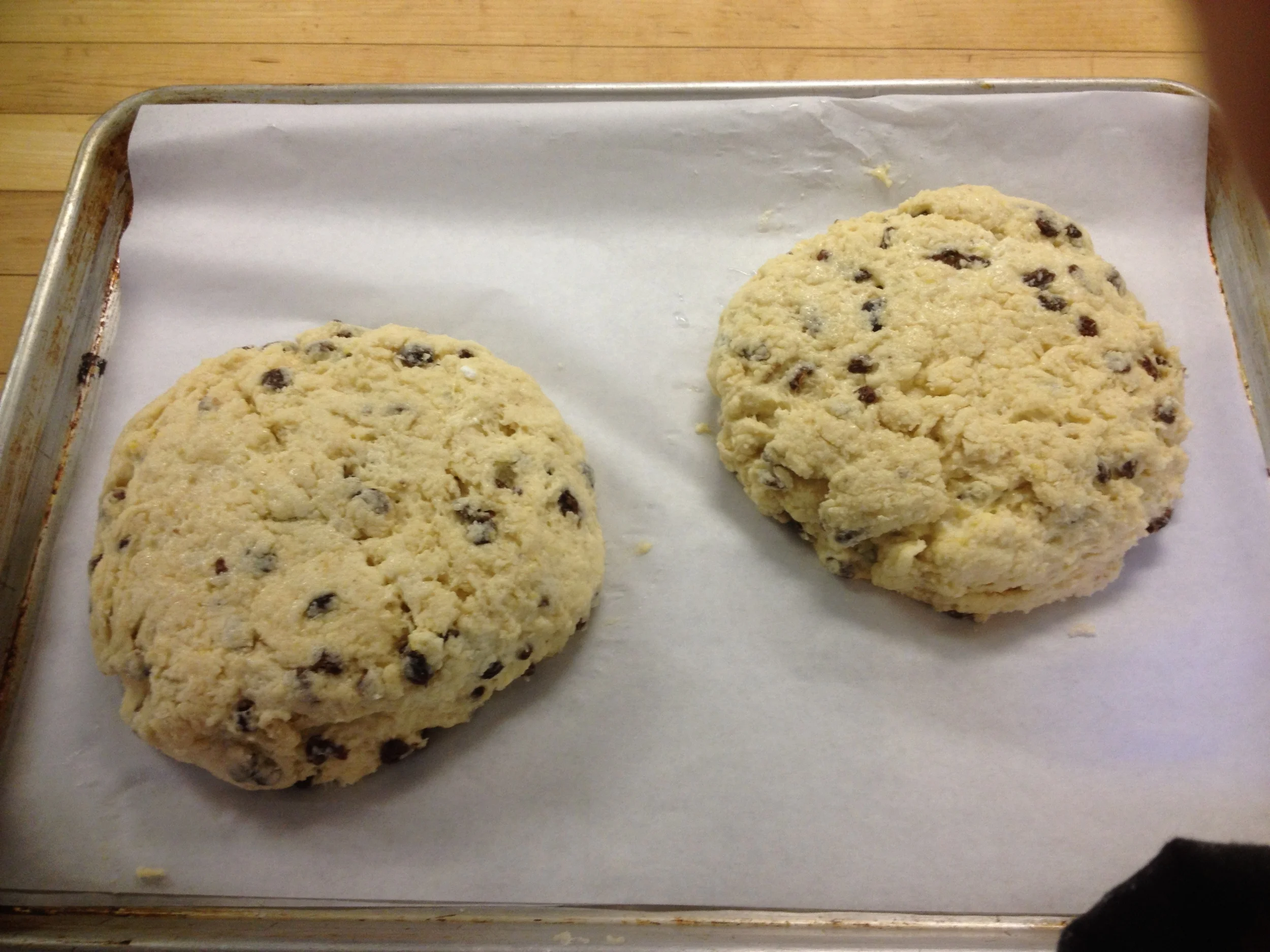Once the dough is mixed, shape it into tow balls and flatten the dough on a sheet of parchment to 1 1/2" thick.