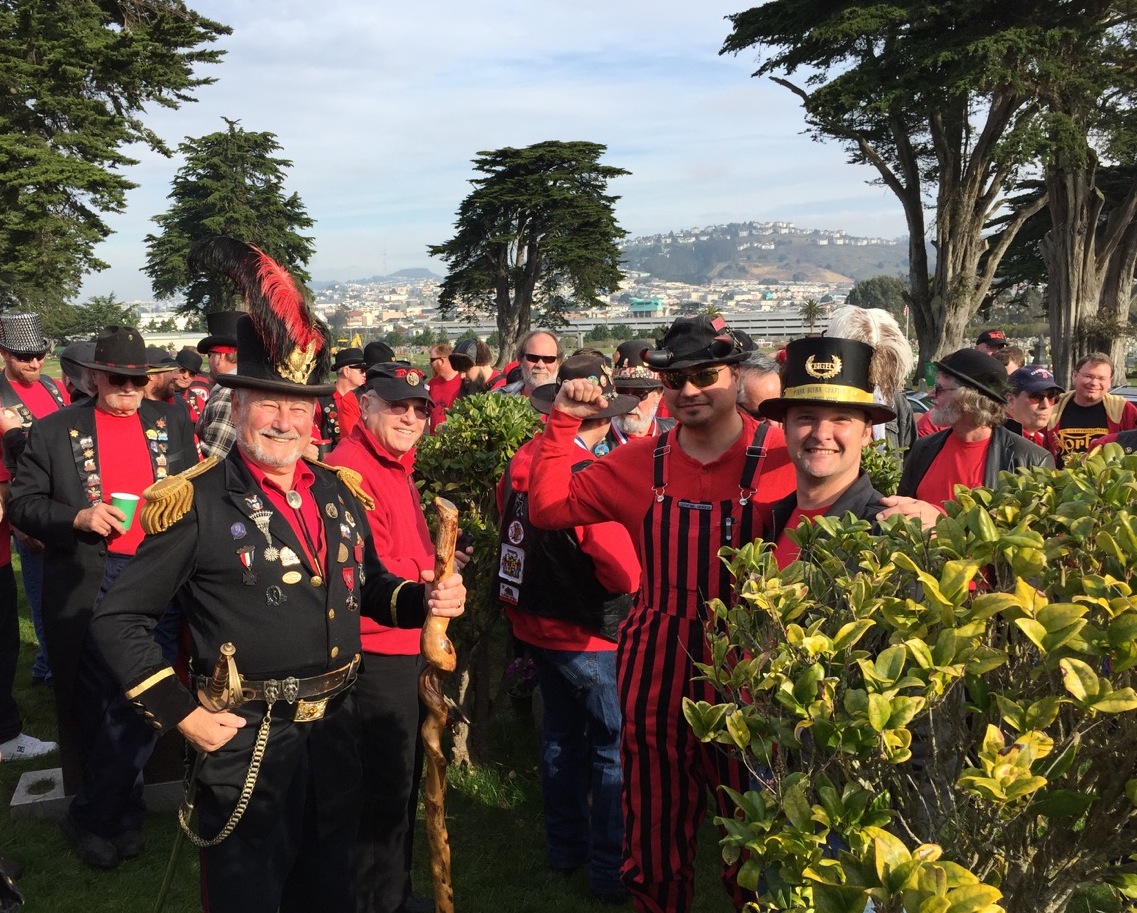 At Emperor Norton's gravesite during the 2015 Emperor Norton Day celebration of E Clampus Vitus. Emperor Norton is played by Rick Saber. Across from the Emperor, in the white-plumed top hat, is Stephen "Scooter" Mitchell, the Noble Grand Humbug (something like the chapter president) of Yerba Buena #1, the E Clampus Vitus "mother lodge." At right (with beard) is the Campaign's own Joseph Amster, who has his own "gig" playing the Emperor. Photograph courtesy of Rick Saber.