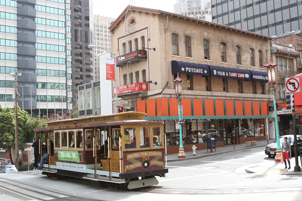 564-574 Grant Avenue in San Francisco, on the southeast corner of California Street and Grant Avenue (formerly Dupont Street) — as seen from the northwest corner of the intersection. The narrow, California-facing side of this 1909 building stands immediately adjacent to the place on the sidewalk where Emperor Norton collapsed and died on the evening of 8 January 1880. 