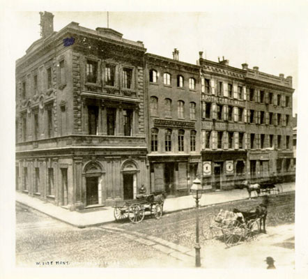 Northwest corner of Commercial and Montgomery Streets, San Francisco, 1866. Montgomery runs north-south in the foreground. Emperor Norton's palace, at the Eureka Lodgings, was a half-block west along Commercial. Photograph uncredited. Source: San Francisco Public Library .