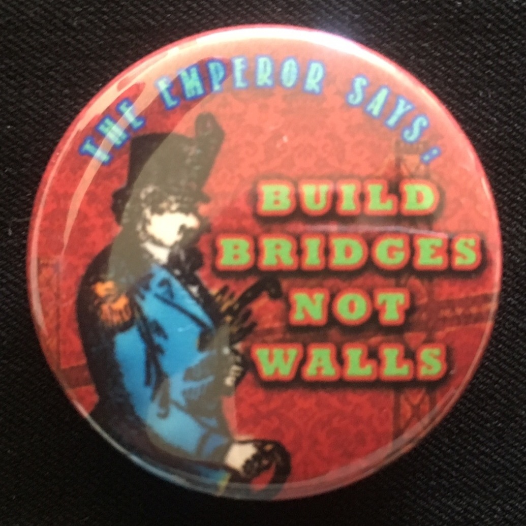   "Build Bridges Not Walls" pin, February 2017, by Aaron Almanza.  This pin features a colorized detail of an illustration of Emperor Norton, viewable  here , that originally accompanied a front-page profile of the Emperor that appeared in the  San F