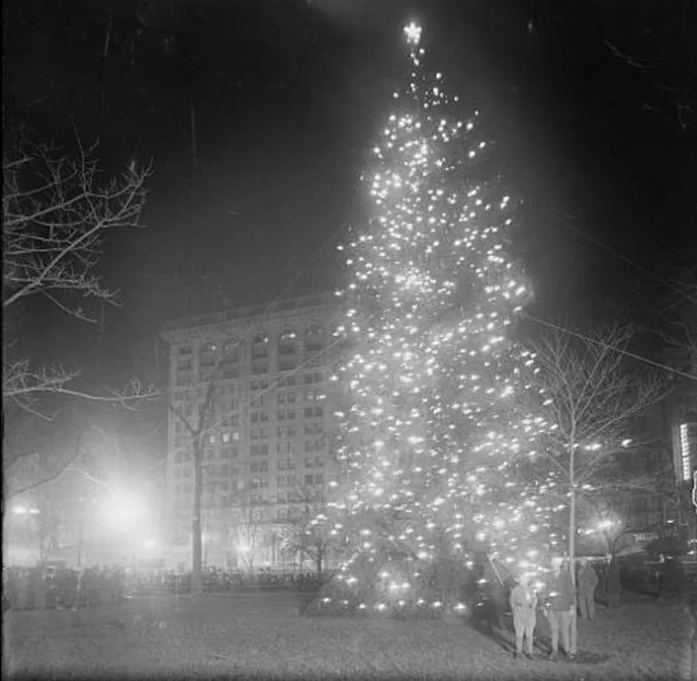 The Christmas tree in Madison Square Park, New York City, on Christmas Eve 1912. This was one of the first outdoor civic Christmas trees in the United States. The other two — in Boston and in Hartford, Conn. — were lit that same evening. Photograph: Collection of the Library of Congress. Source: 6sqft