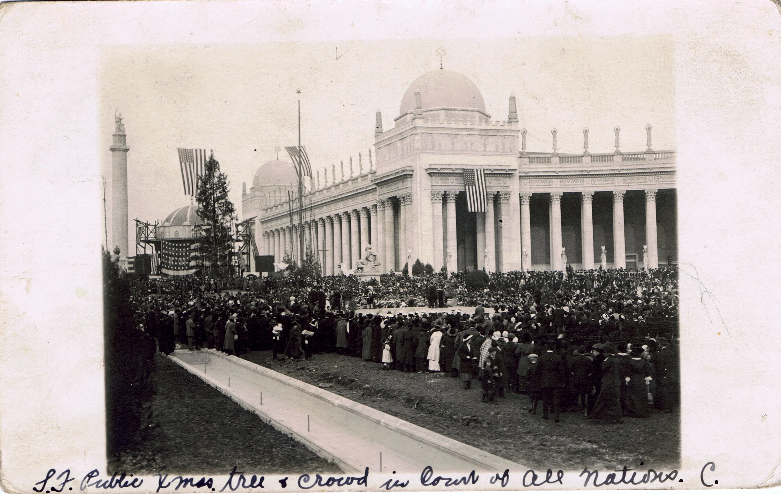 The municipal Christmas tree in the Court of the Universe at the Panama-Pacific International Exposition, San Francisco, Christmas Day 1914. The PPIE grounds are still under construction. Click for a wonderful much-larger view. Photo postcard in the private collection of Glenn Koch. Source: Glenn Koch.