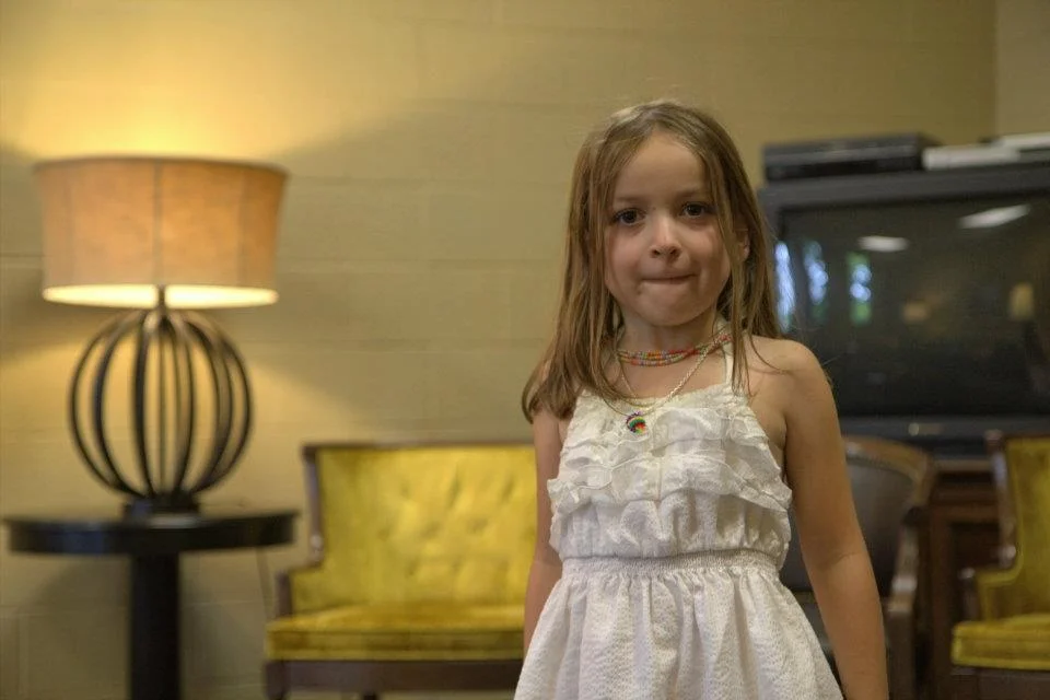 This is a shot I quickly took on my Rebel when I had a free moment. This was from my first year of doing other people's weddings. Poorly lit, grainy, colors are all off (aside from my daughter not having her hair done and making a face).