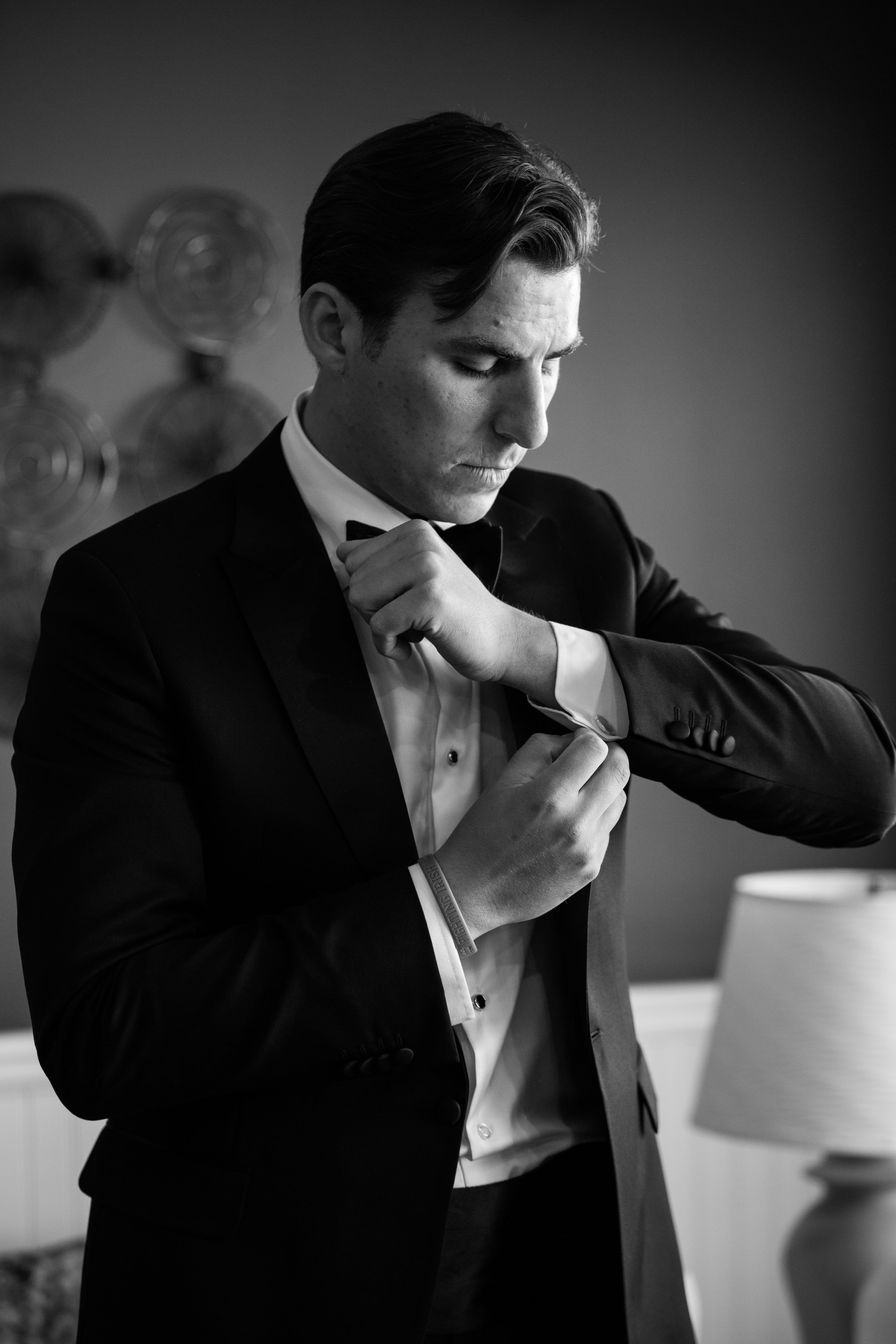 I get sent to take photos of the guys getting ready all the time. I love putting grooms right by the window and working with that dramatic lighting. Taken for Jennifer Mayo Studios.