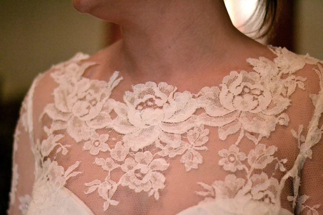 I reapplied roses I cut out from the French lace onto Rhona's neckline to create a more organic soft look . 