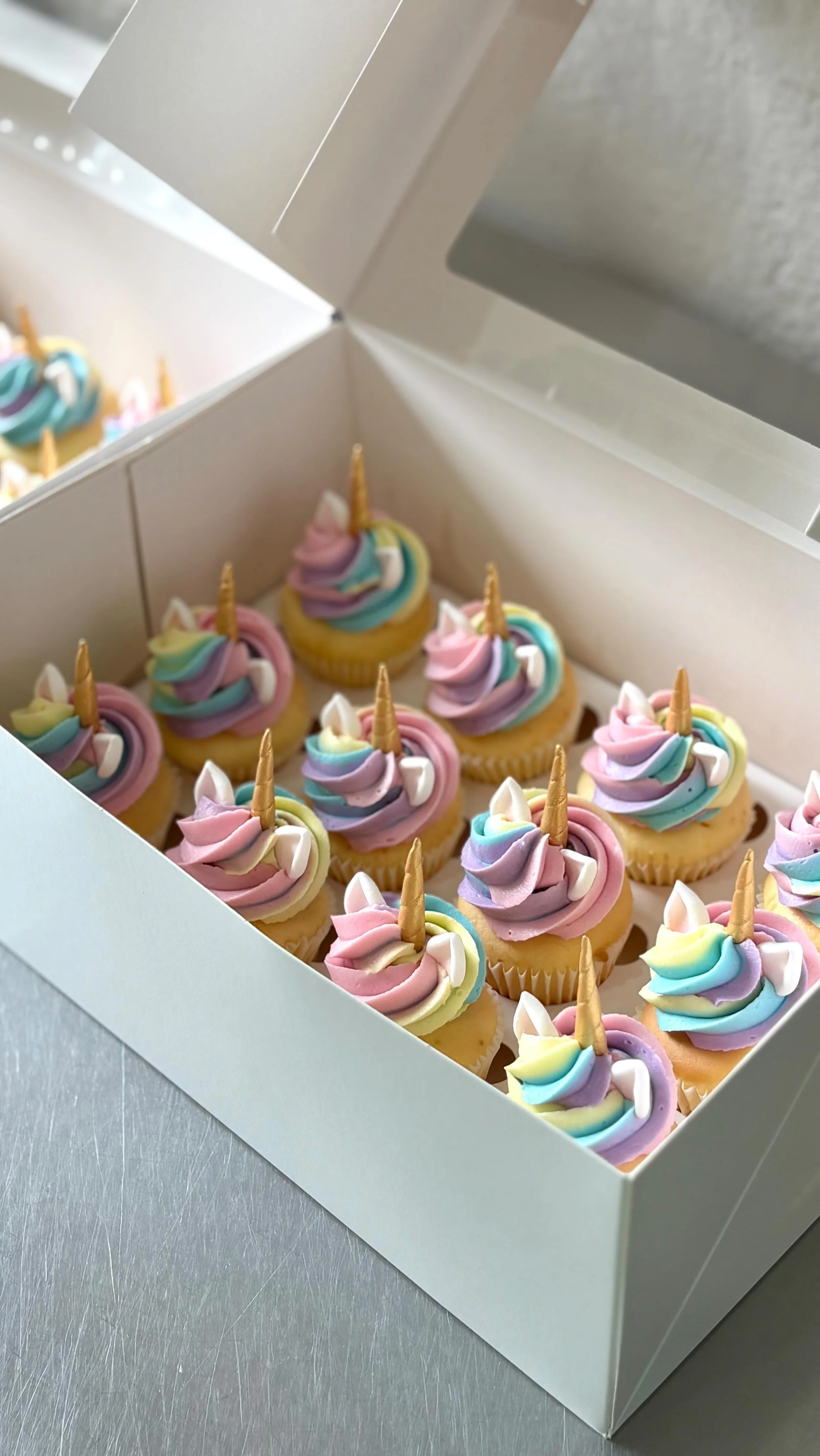 Want to know the easiest way to impress your 6 year old party guests? Our rainbow unicorn cupcakes! 🧁Pictured here is our bite size vanilla cupcakes with a rainbow vanilla buttercream swirl, mini gold icing horn and edible ears! 🌈🦄 Like and save t