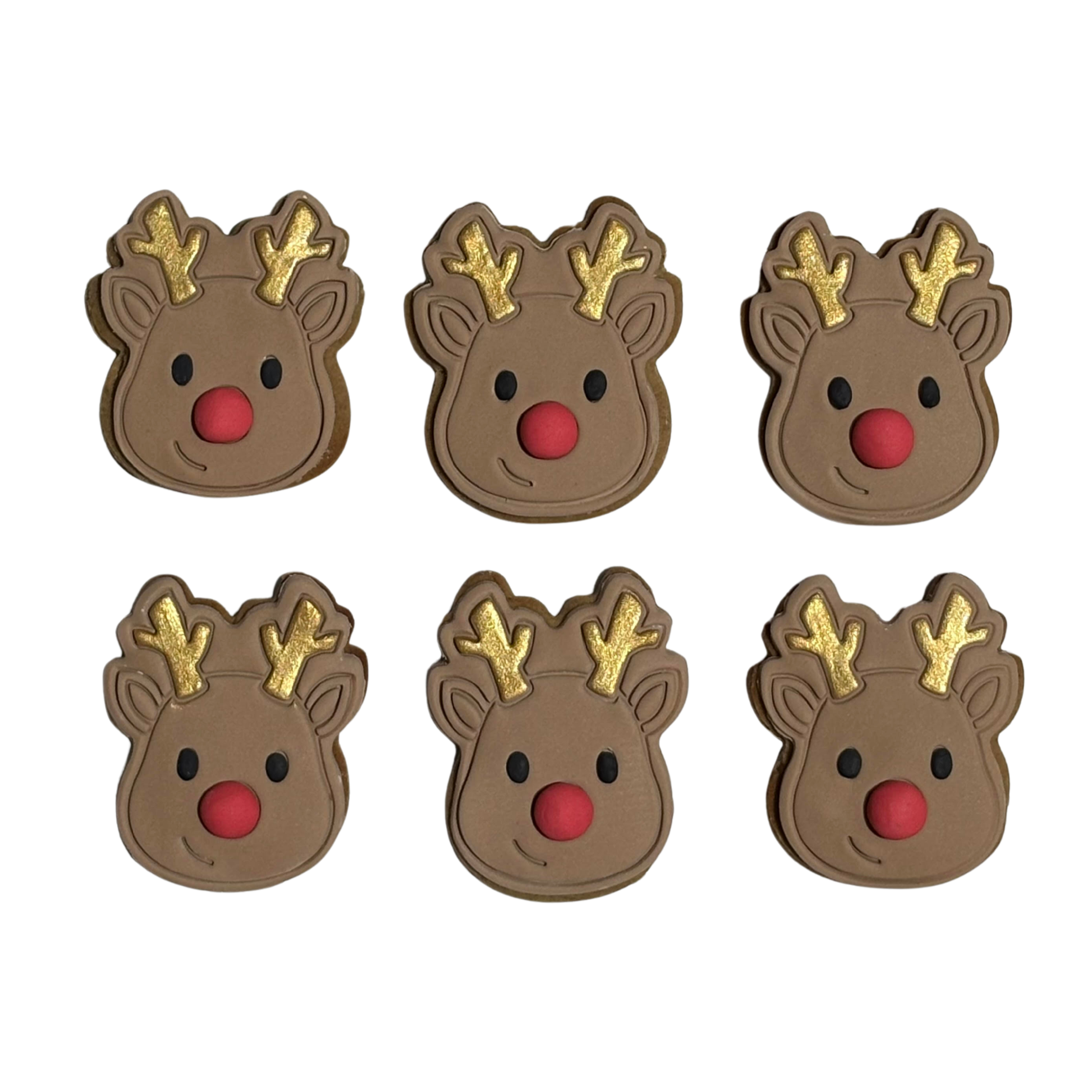 Cute Rudolph the red nosed reindeer face imprinted fondant cookies. A light brown fondant iced cookie with little black eyes, gold antlers and a 2D red nose.
