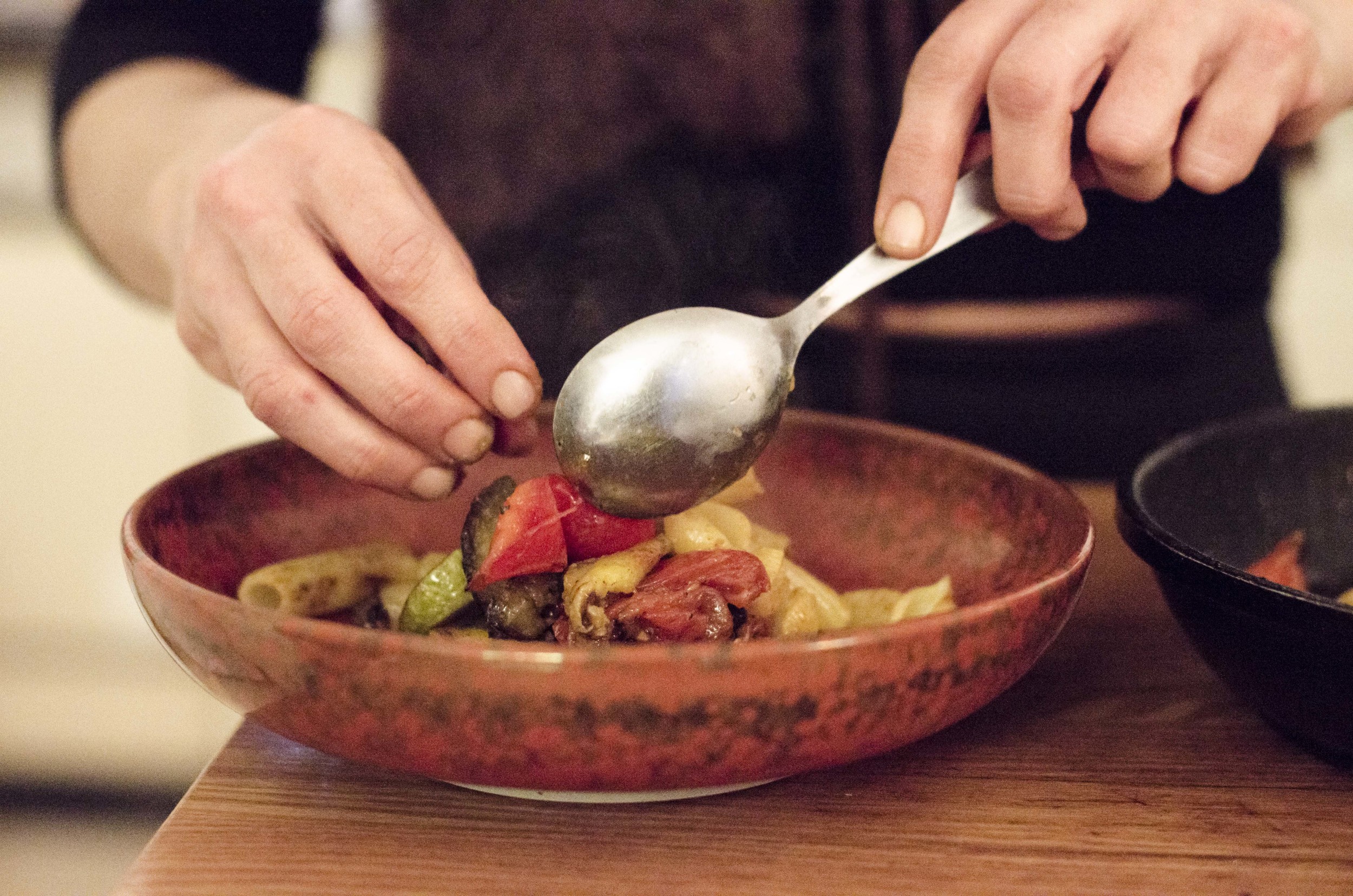 Naama's plating the dish