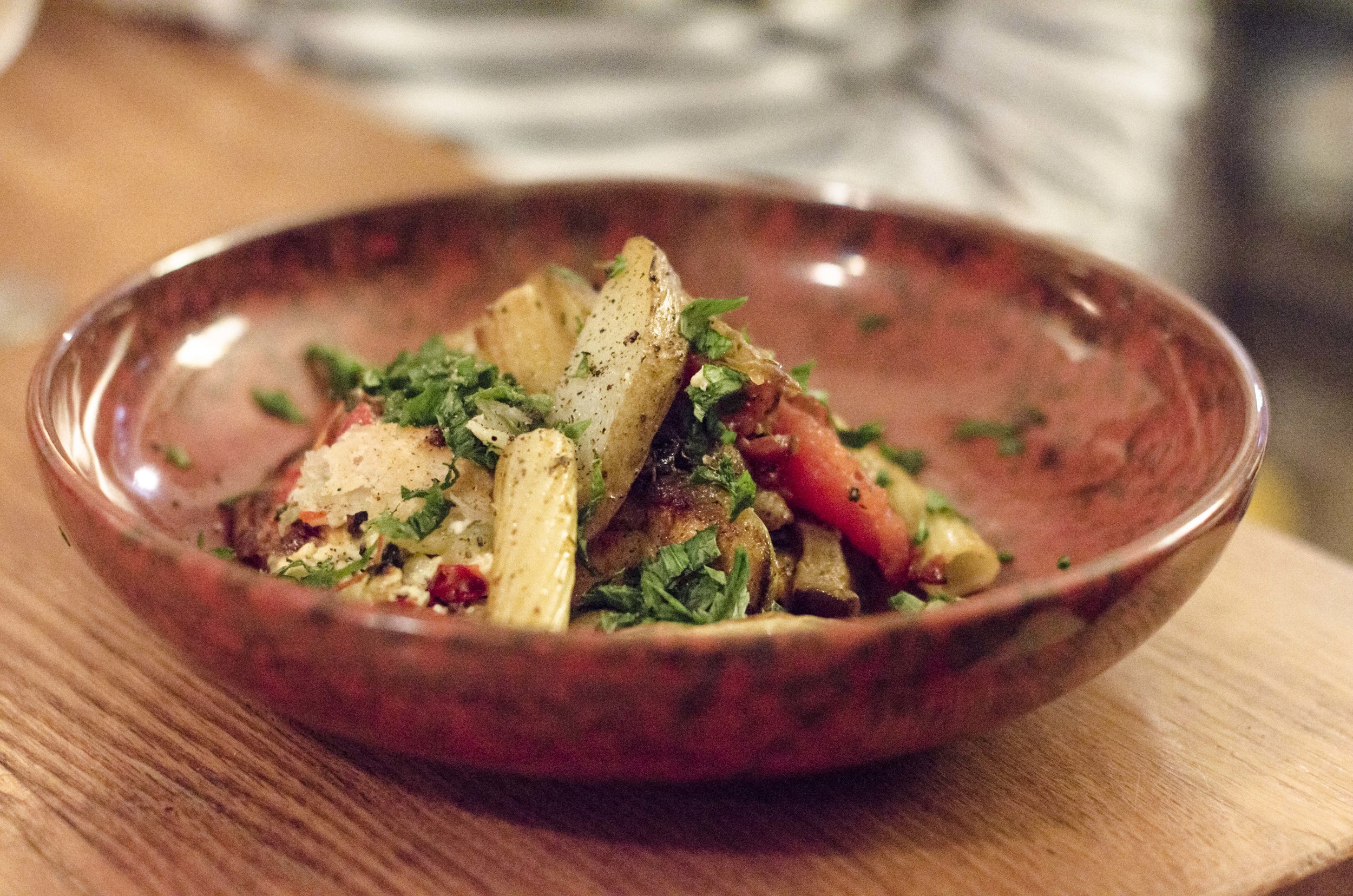 Potato cooked in the oven, Rigatoni Pasta with pan grilled tomatoes, eggplant and zucchini, and parsley on top.