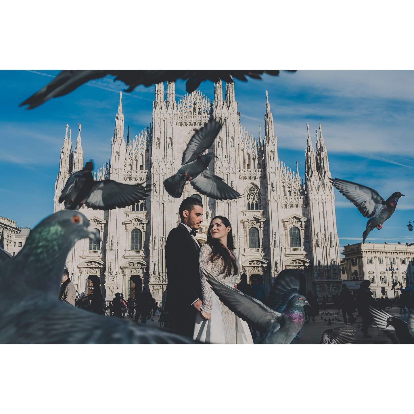 Milan, Italy: On the Duomo Square there are about 1322 pigeons. To have them flying in this photo we had to feed half of them!!!! 😂 It was so worth it! So worth it &hearts;️ Amazing couple!!! Unforgettable memories :) #milan #italy #photoexpertsmagi
