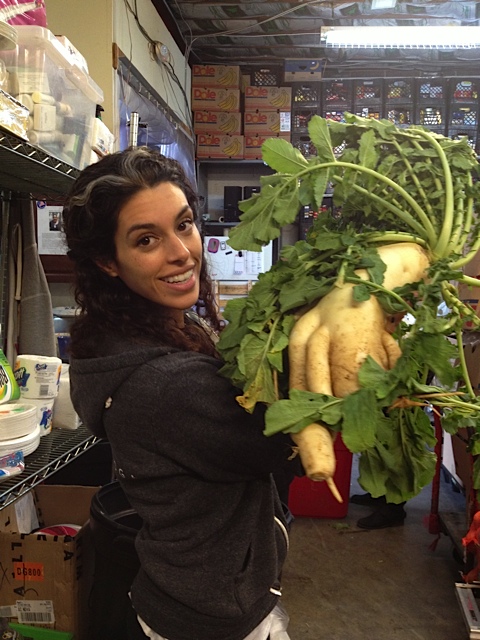  Yoga + Weights instructor, Jenna, holding a child-size Daikon radish!