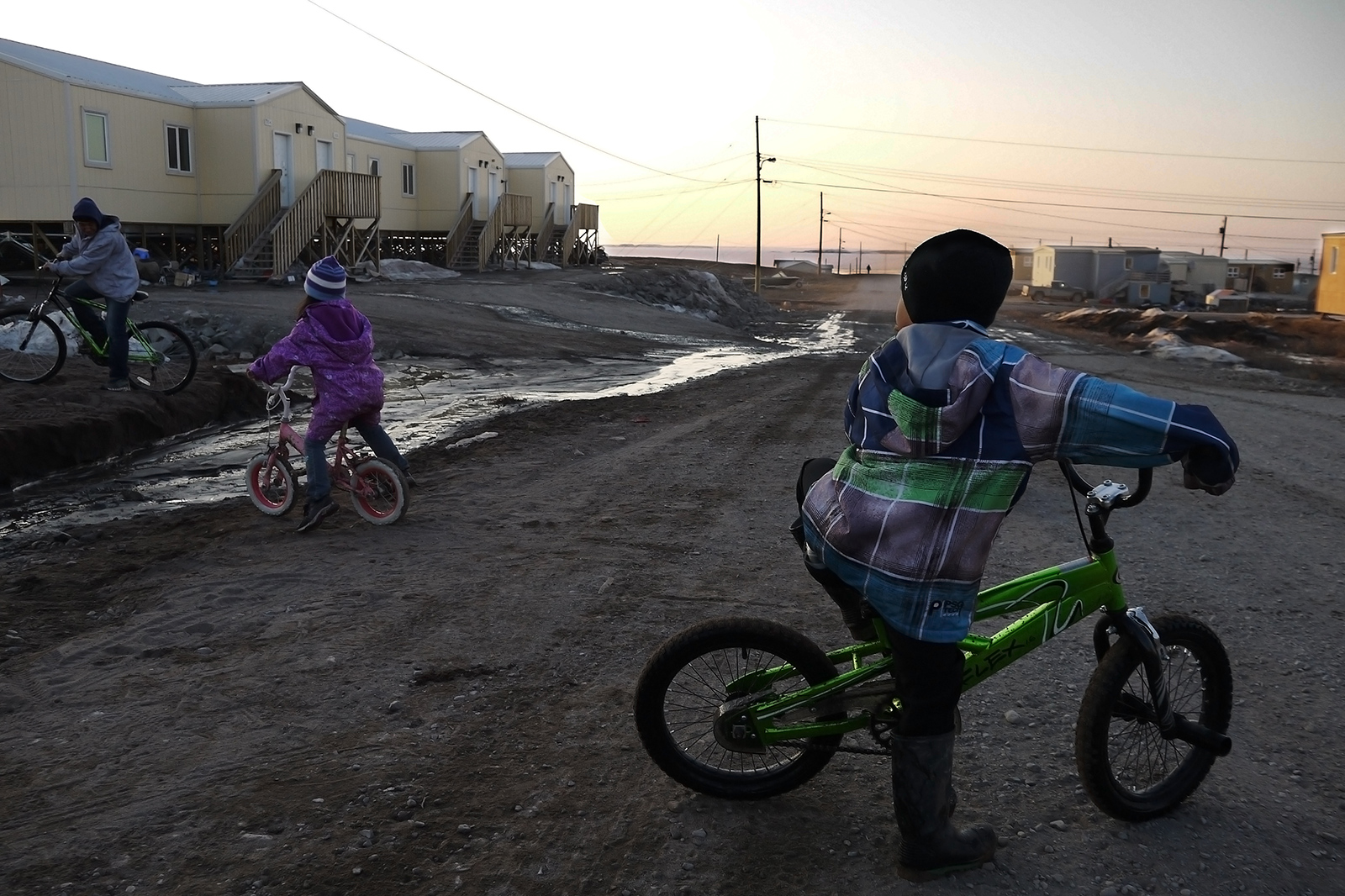 Kugluktuk: Children biking at sunset