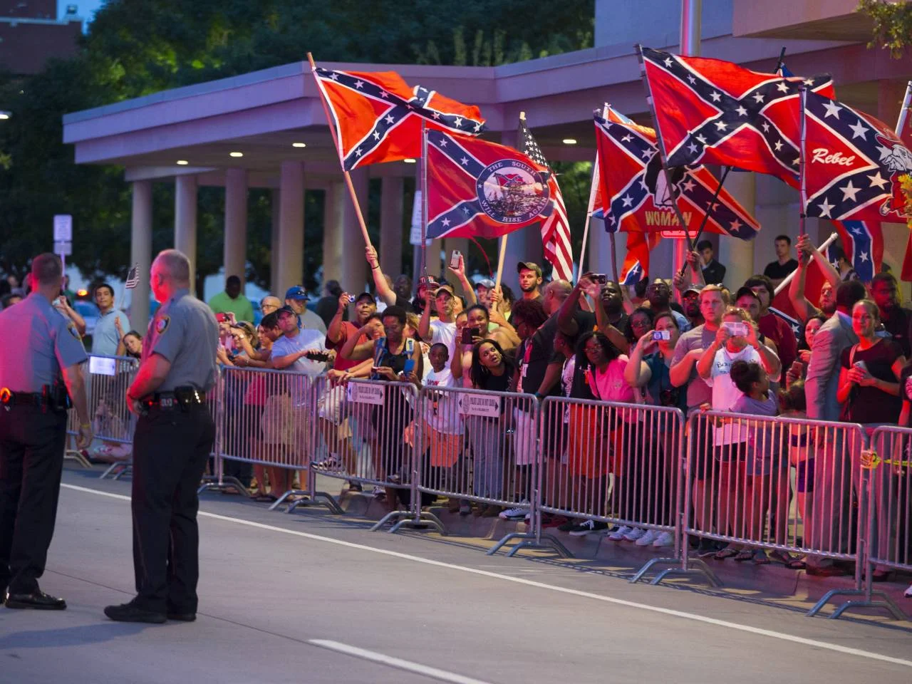 People wave Confederate flags outside the hotel that President Barack Obama is staying the night, on Wednesday, July 15, 2015, in Oklahoma City. Obama is traveling in Oklahoma to visit El Reno Federal Correctional Institution.(Credit: AP Photo/Evan Vucci)