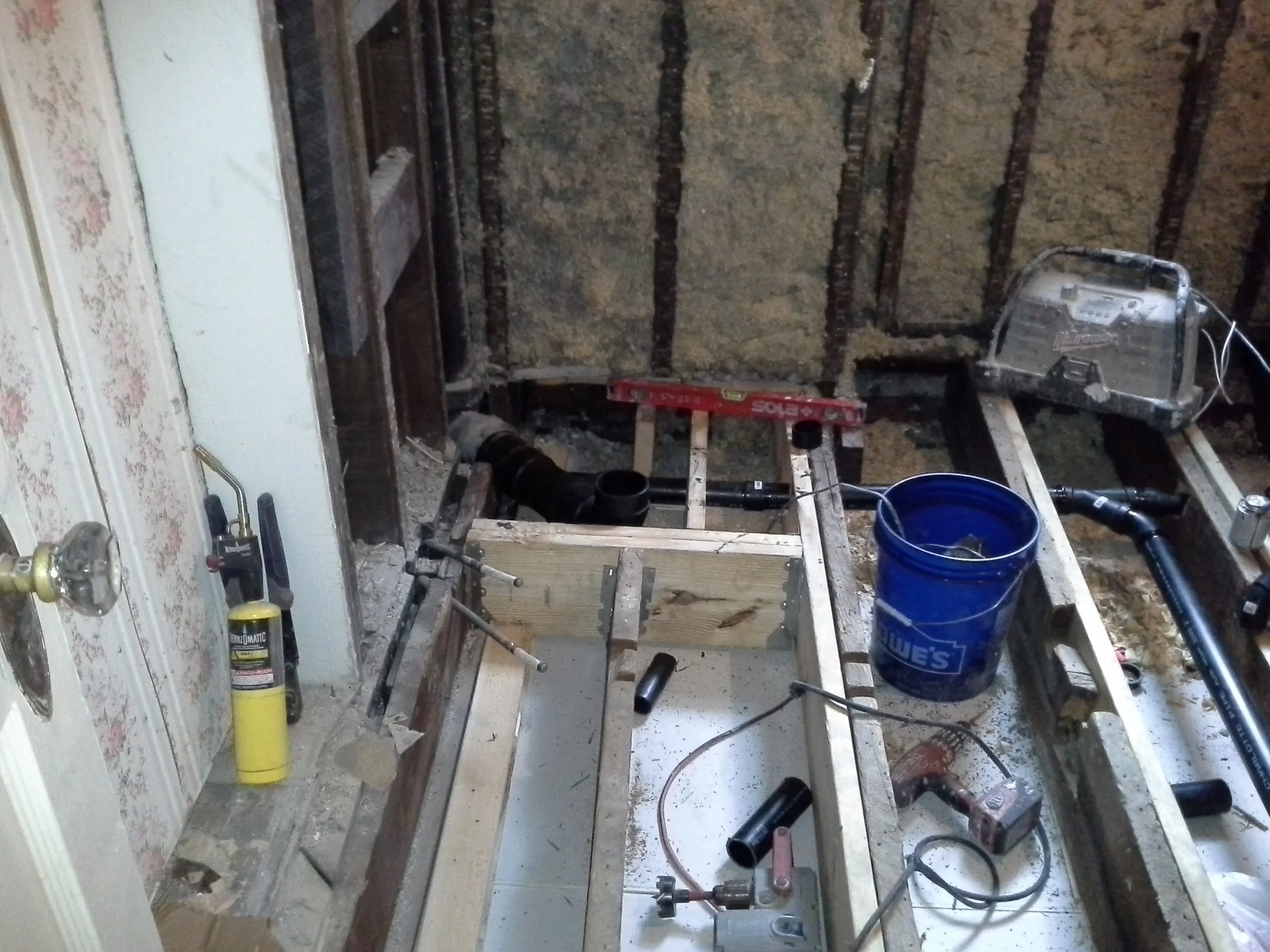 Installation of new floor joists; sistering on to existing joists and spanning from each load bearing wall. Also installing headers where plumbing is needed 