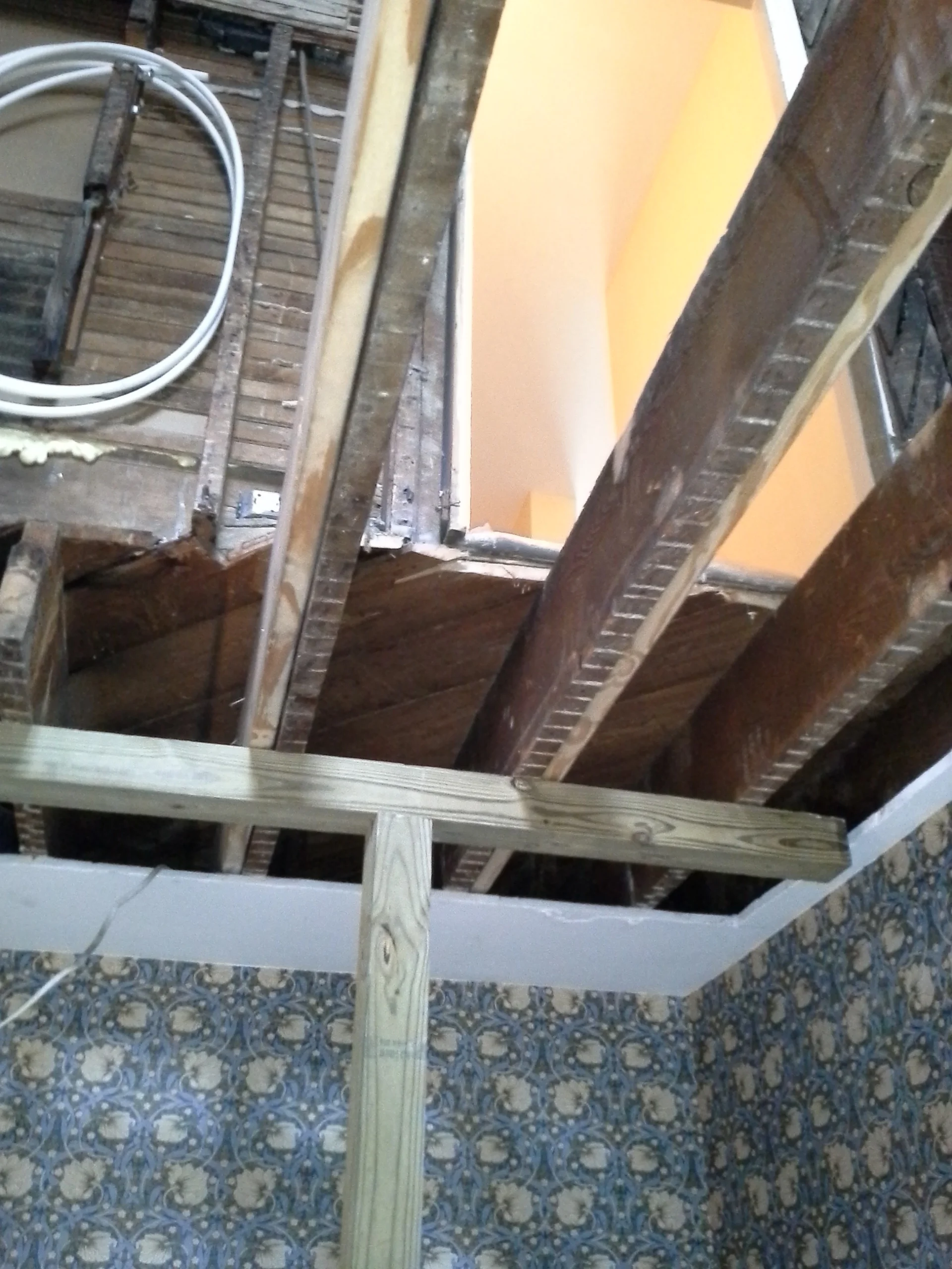 A support post was used to jack up existing floor joists to level.