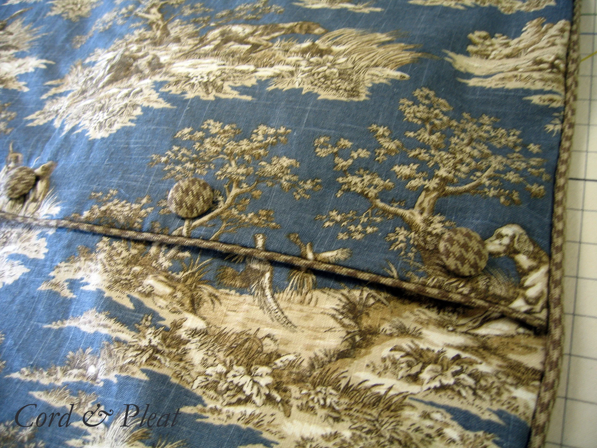 Close up photo of cording and button detailing on duvet cover.