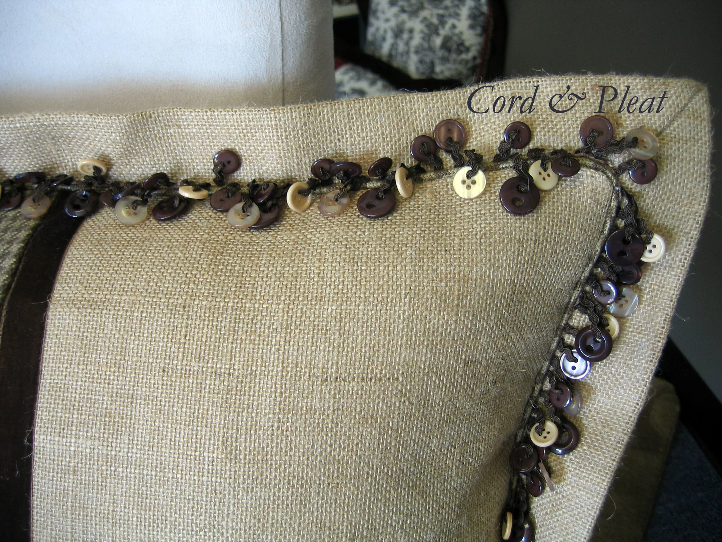 Close up photo of Decorative Trim, Micro-cording & mitered flange on lumbar pillow.