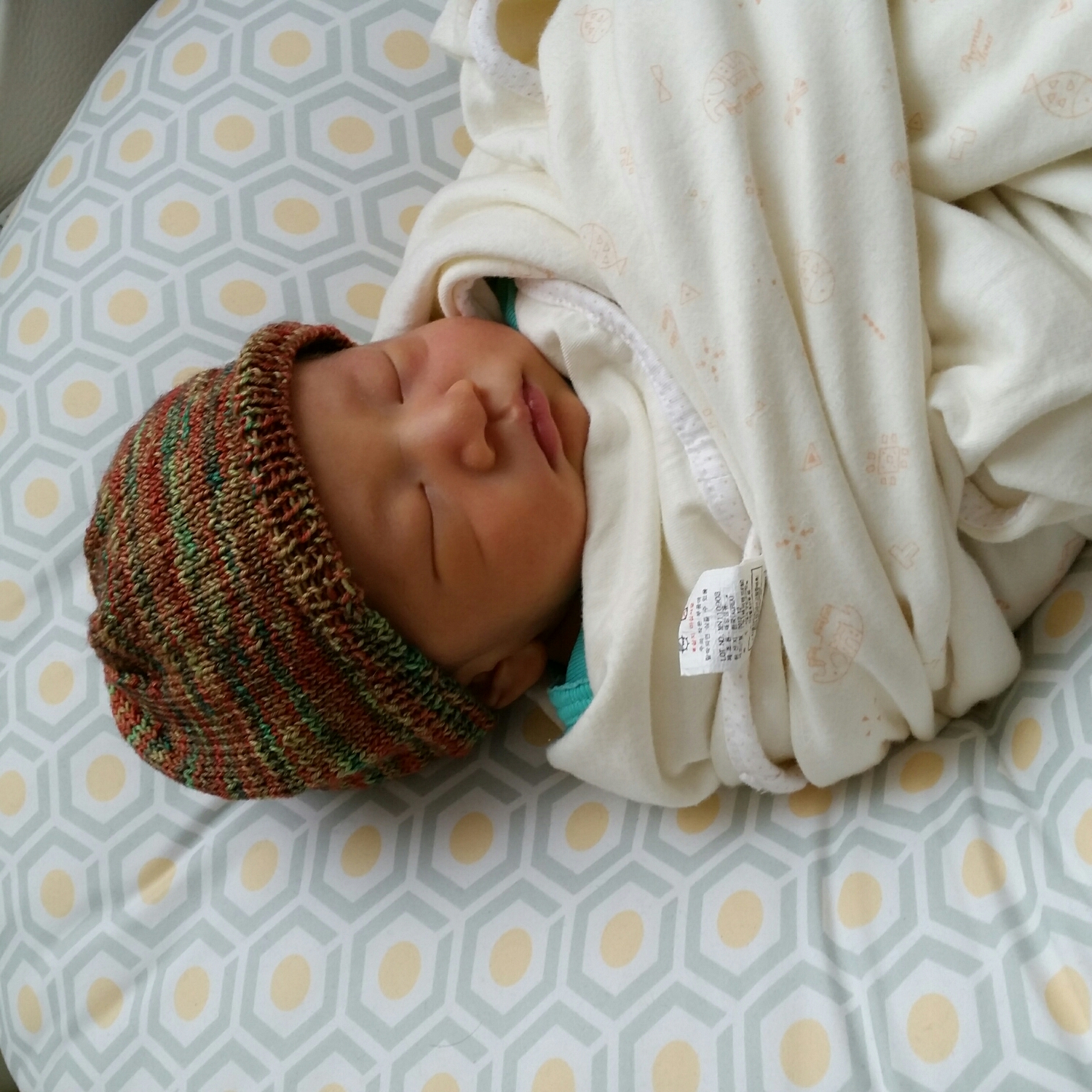 Baby Logan wearing my hand dyed Merino/Silk blend newborn hat 