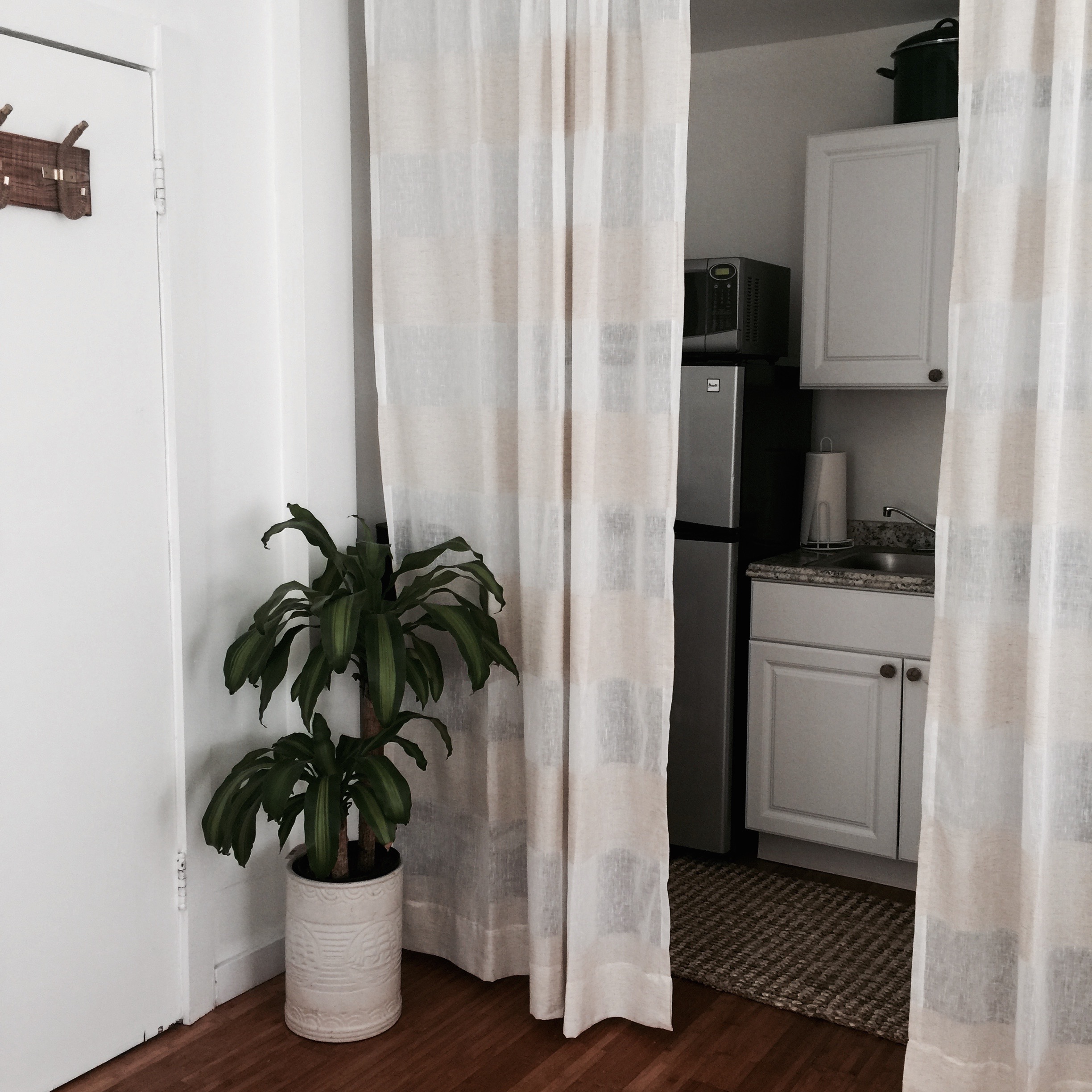 The kitchen is by the front door and there are curtains to cover the kitchen area if you like.