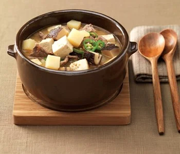 Doenjang Jjigae (Soybean Paste Stew) - This stew-like Korean dish is made by boiling an assortment of ingredients such as meat, clams, vegetables, mushrooms, chili, tofu, and soy paste.