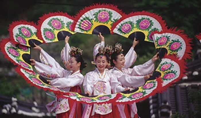 Buchaechum (Fan Dance) - A traditional form of Korean dance usually performed by groups of female dancers holding fans with floral designs on them.