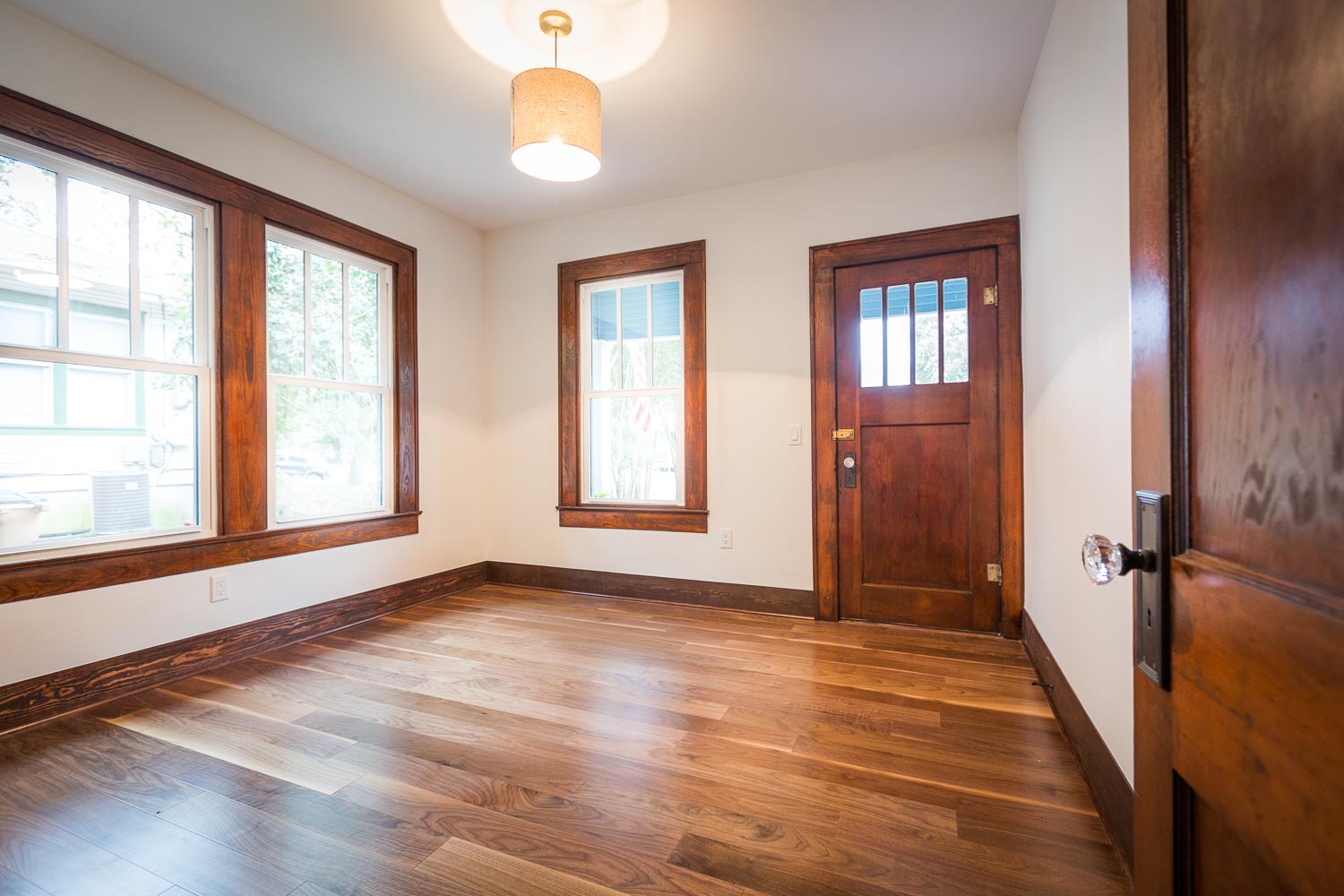 This room shows the beauty of the dark wood trim, new windows, walnut floors, original bronze hardware with (new) crystal door knobs, and natural light. 