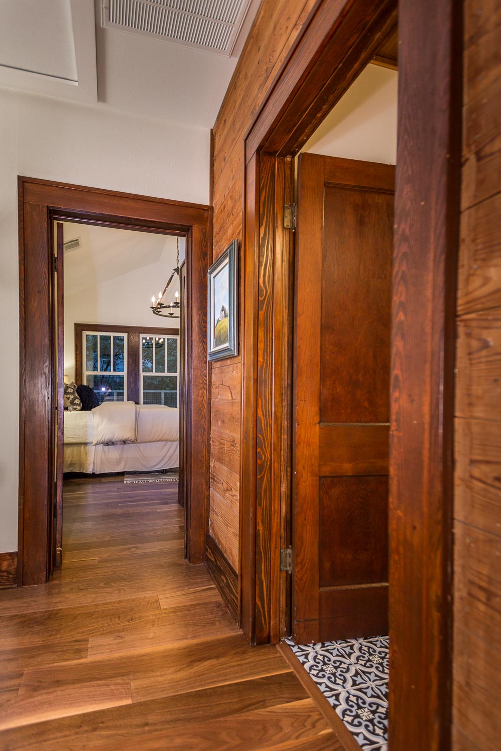 The hallway is one of the most interesting areas of the Austin bungalow. The original shiplap and trim is showcased. My favorite flea market painting hangs in the hallway and brings all the colors together. 
