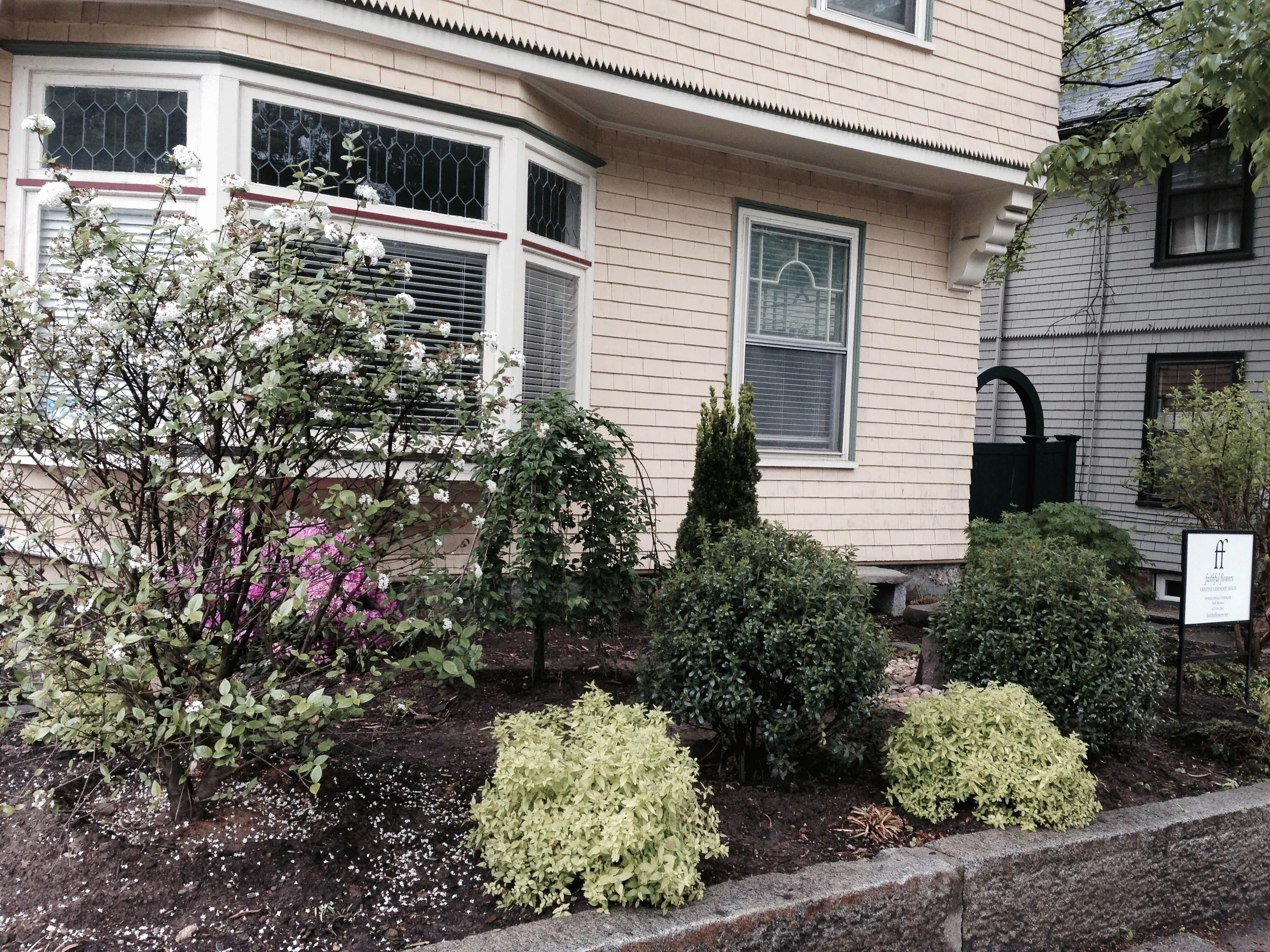Plantings hide a birdbath and bench for a little boy to discover!