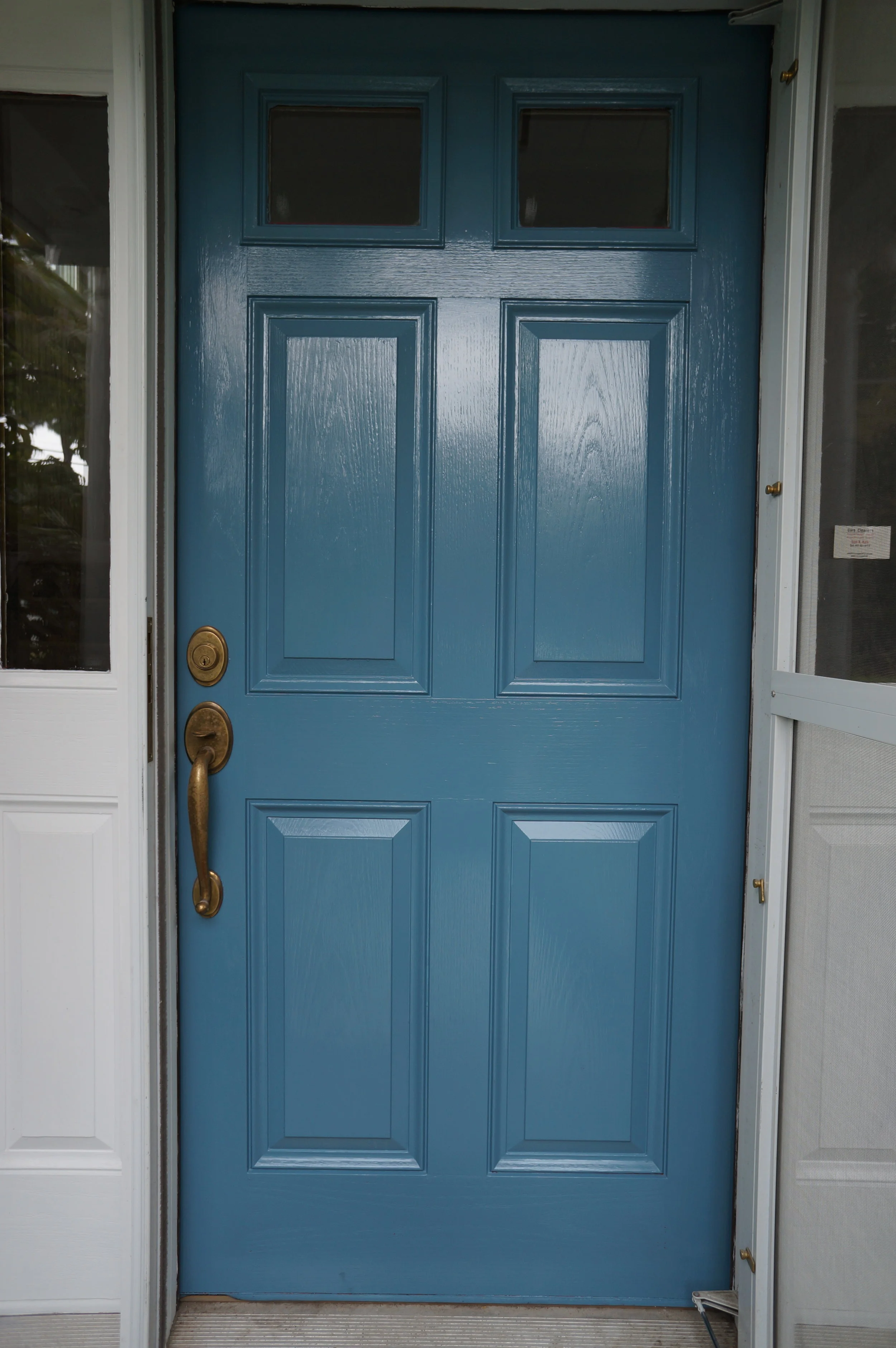  We painted the door a beautiful blue from Benjamin Moore's Grand Entrance paints. The window panels were returned to a calming cream color. 