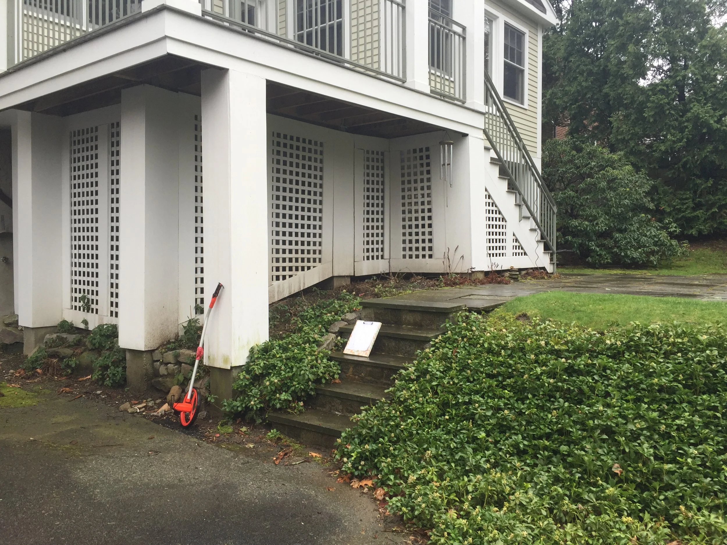  A new wall cleans up the area directly under the deck. The asphalt driveway is capped off by a handsome cobble apron. 