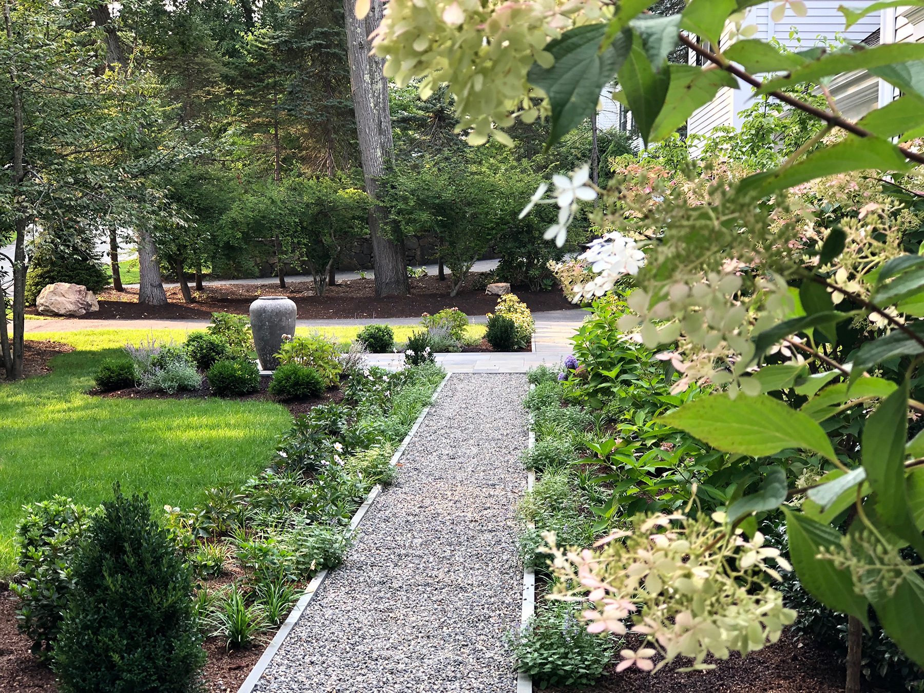 We turned the long paver walkway into a natural bluestone chip pathway connecting the front door with the new landing in front of the mudroom.