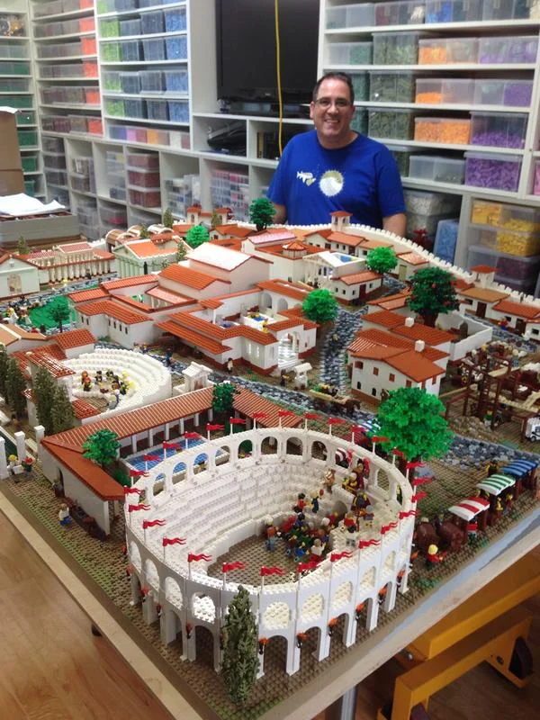 LEGO Professional Builder Ryan McNaught with LEGO Pompeii. Image courtesy of the Nicholson Museum. 