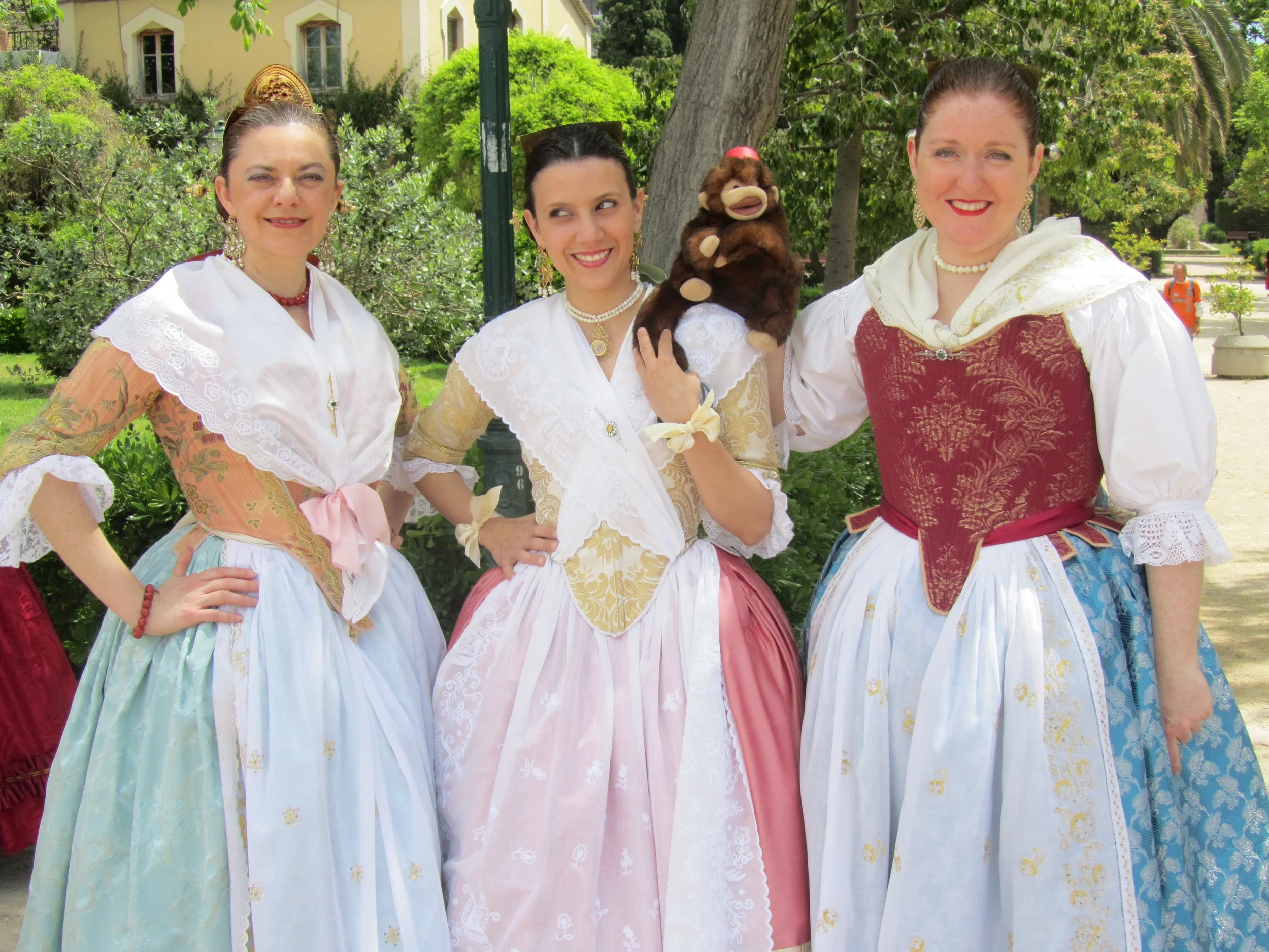 Manu the mind reading monkey in Valencia with some girls in their Falla finery.