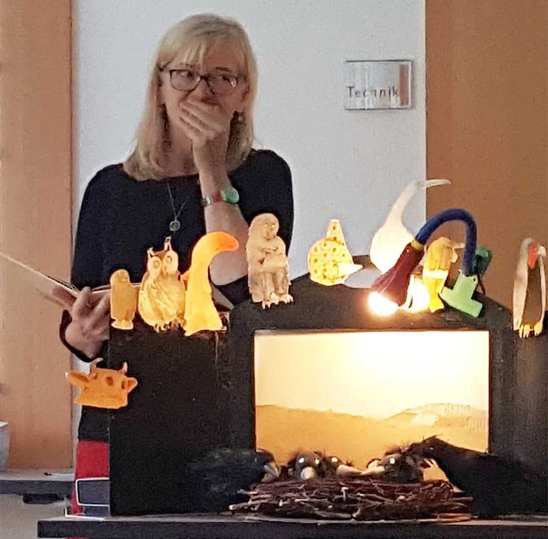 Bansch at a school visit with her raven puppets