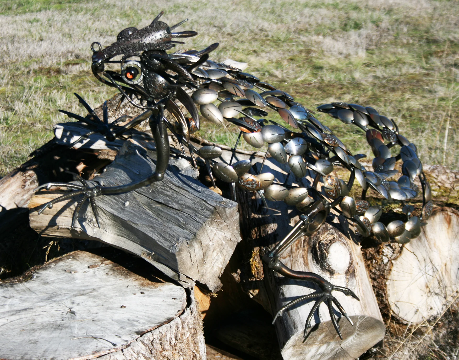 Lizard on the wood pile (18” tall x 32” wide x 42” long) Sold
