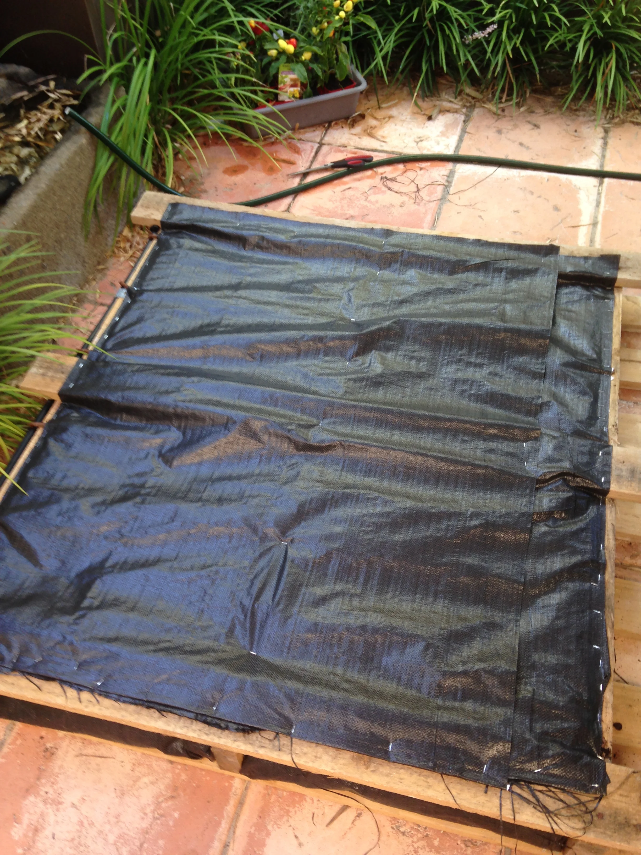 Add potting mix, and then the back cover of weed mat. Make sure to staple well to keep the soil in.