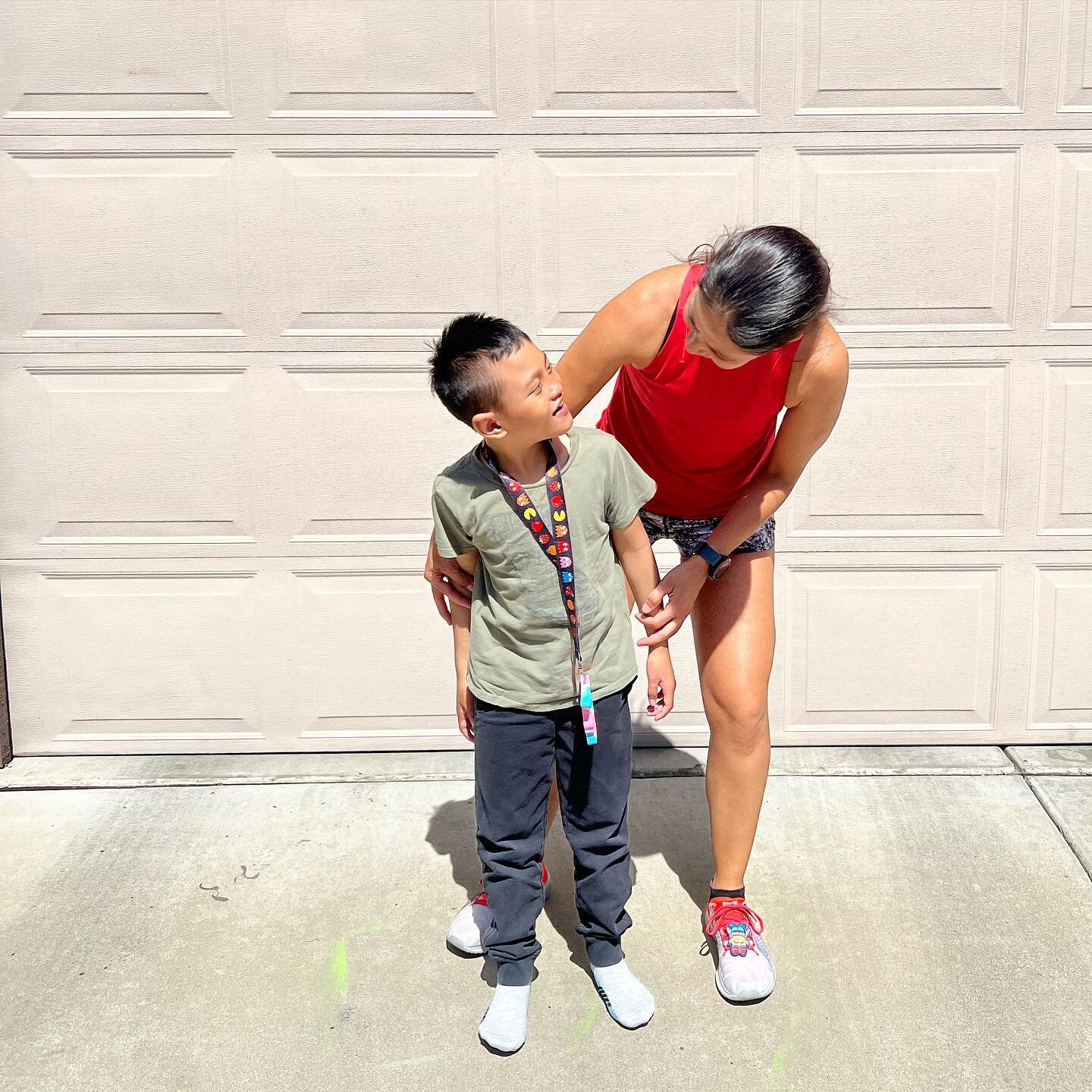 Friday!  We are so happy for Friday. Long week, ending it with a little joy - running! 

What&rsquo;s brought YOU joy this week or even just today?  Celebrate the small things that put a smile on your face. 

ID: Asher and mom standing in front of ga