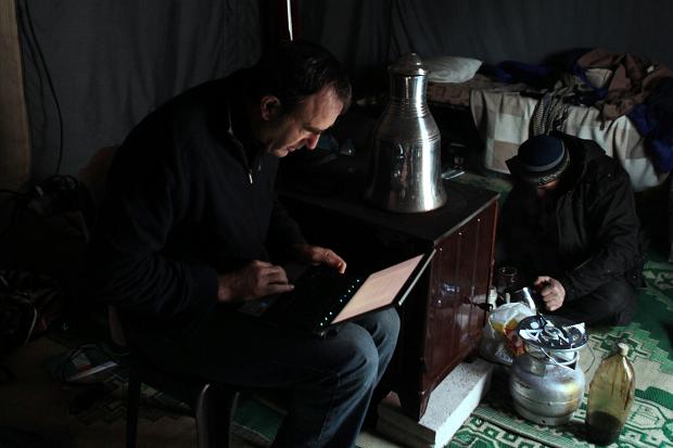   Martin Fletcher writes an article in a tent in Syria&nbsp; Times photographer, Tom Pilston 