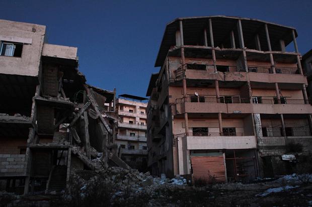   Night falls over damaged apartments in Salma&nbsp; Times photographer, Tom Pilston 